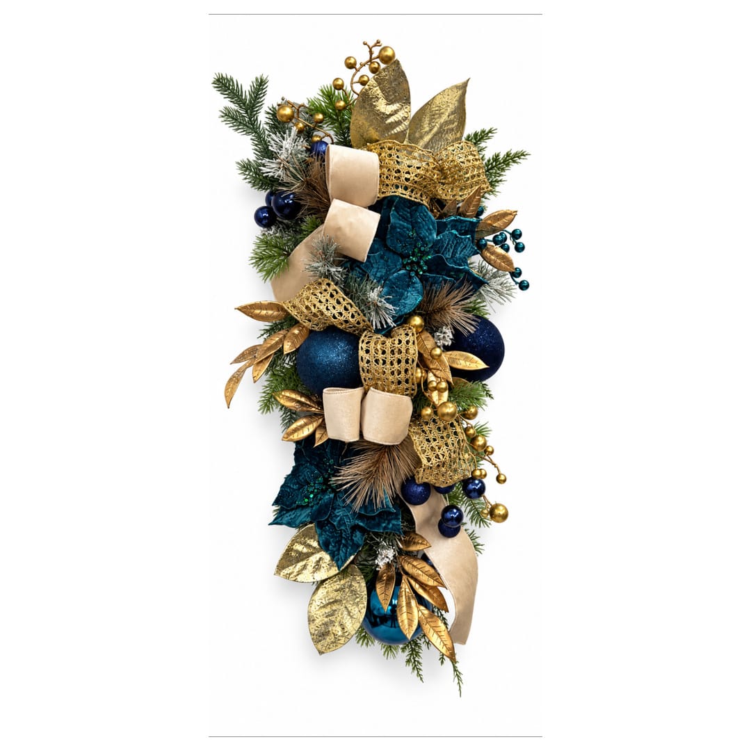 Blue and gold holiday swag with ribbon, ornaments, and evergreen sprigs