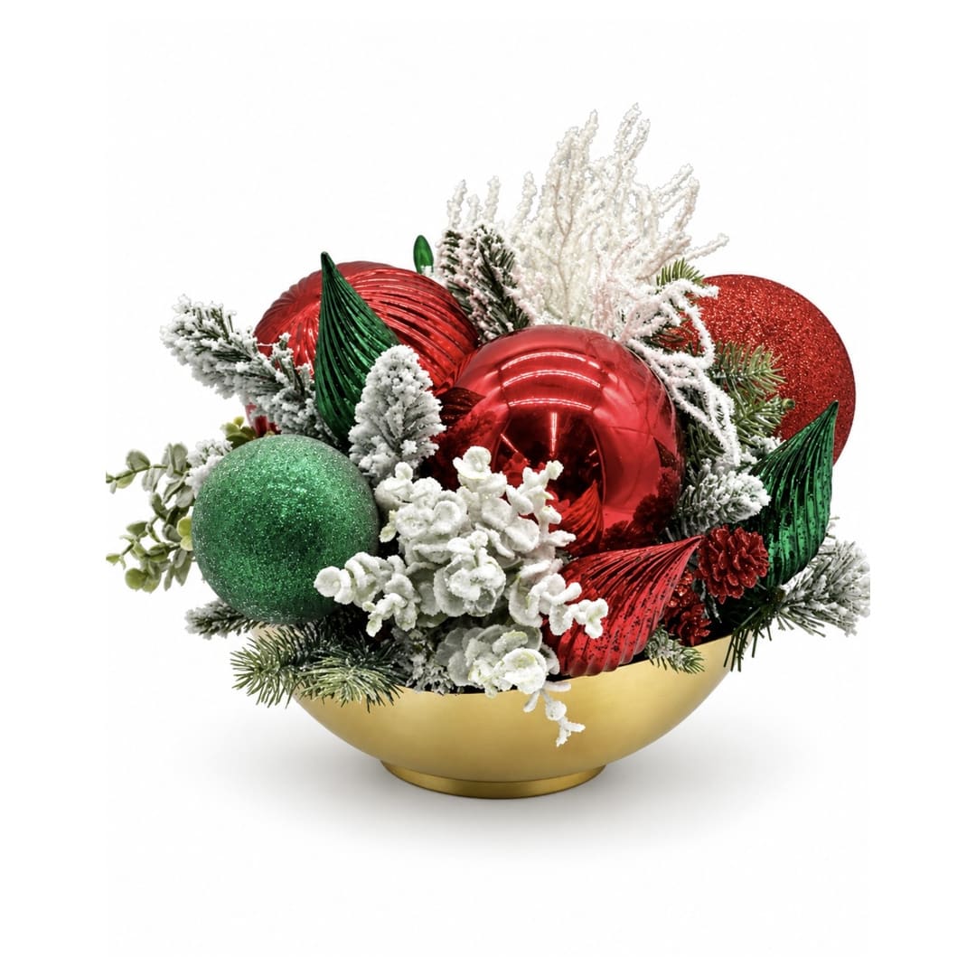 Holiday arrangement with red and green ornaments in a gold bowl