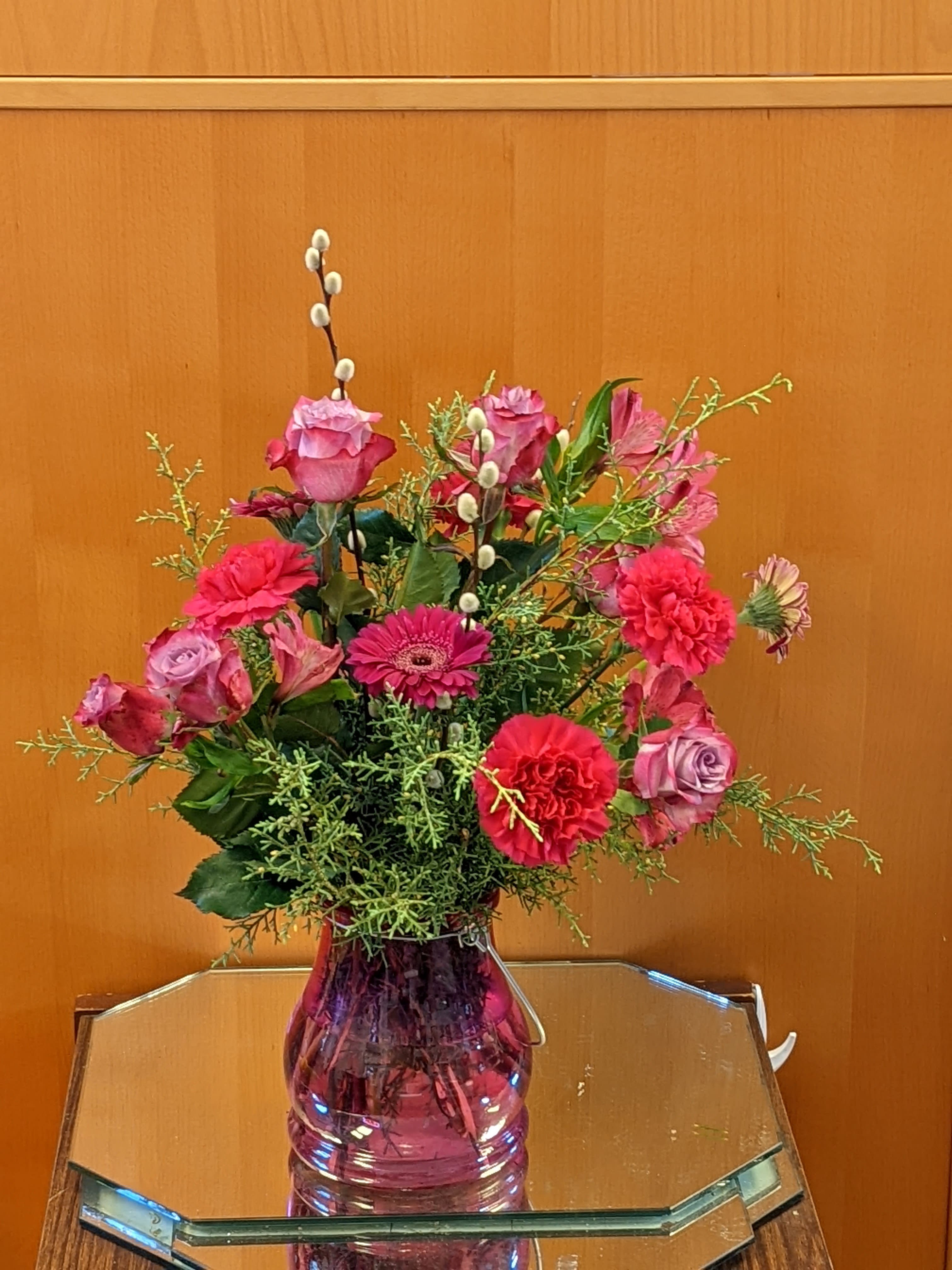 Pink mixed flower arrangement in a glass vase