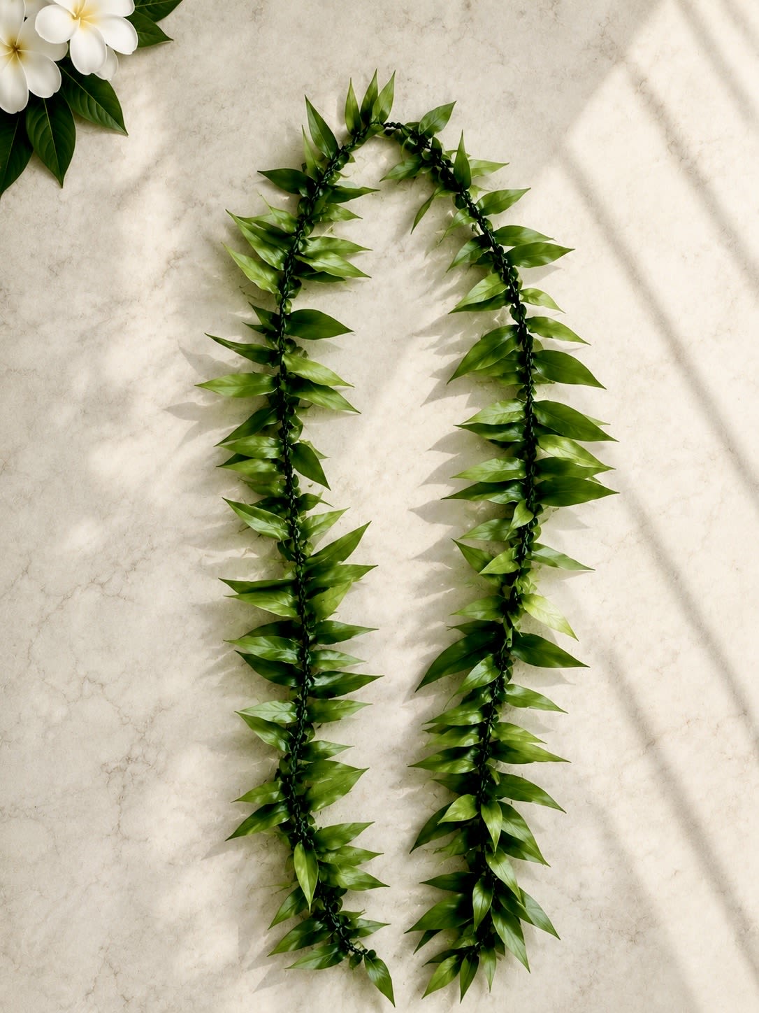 Ti Leaf Lei - Our Ti Leaf Lei is handcrafted in the traditional Hawaiian style using fresh ti leaves. This elegant green lei is perfect for graduations, weddings, retirements, welcoming ceremonies, and other special occasions.  Approximate Length: 72"  Due to the natural characteristics of fresh ti leaves, slight variations in color and appearance may occur. 