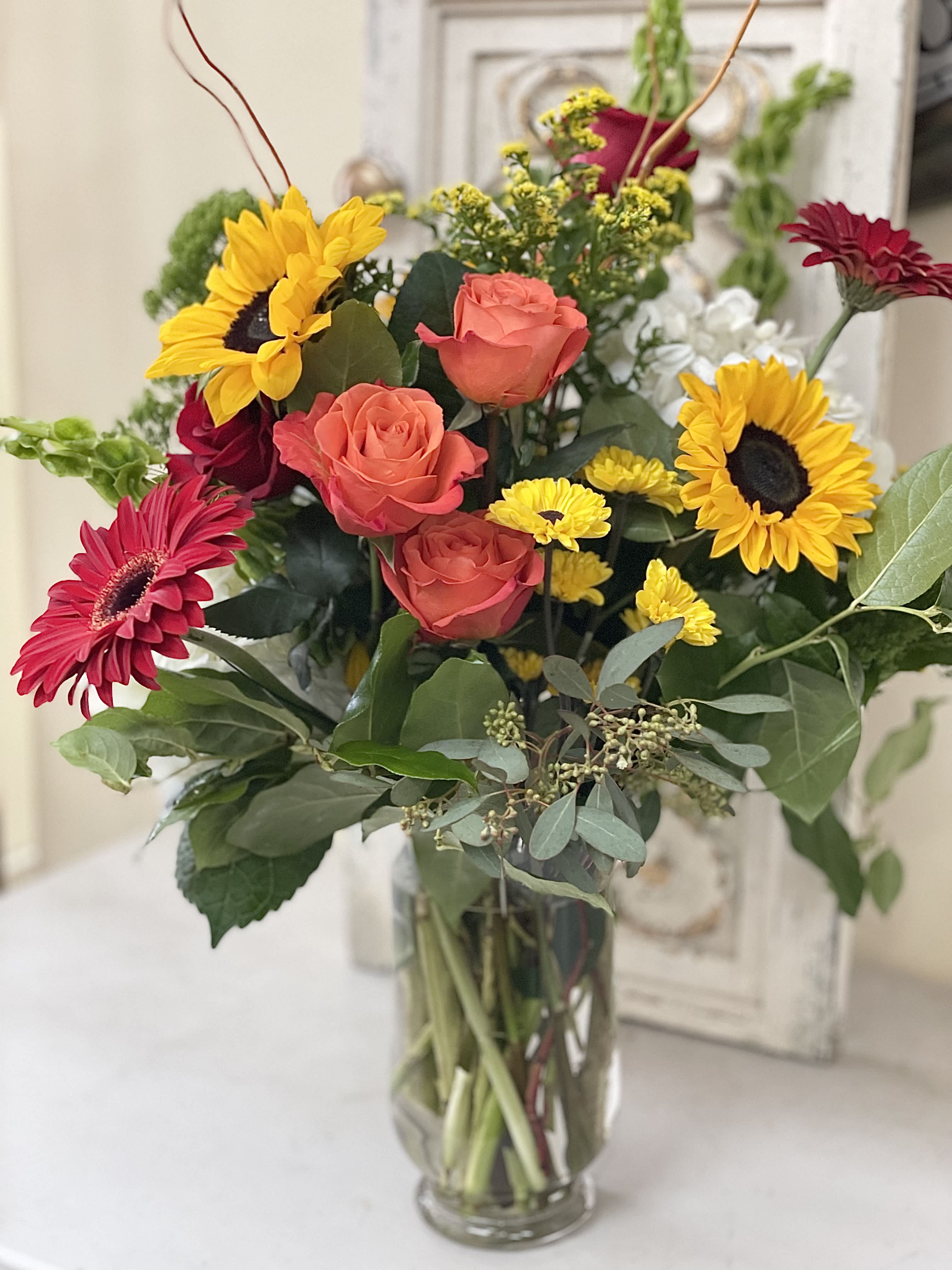 Color - An interesting collection of bright color designed with greens. This arrangement will brighten any room.