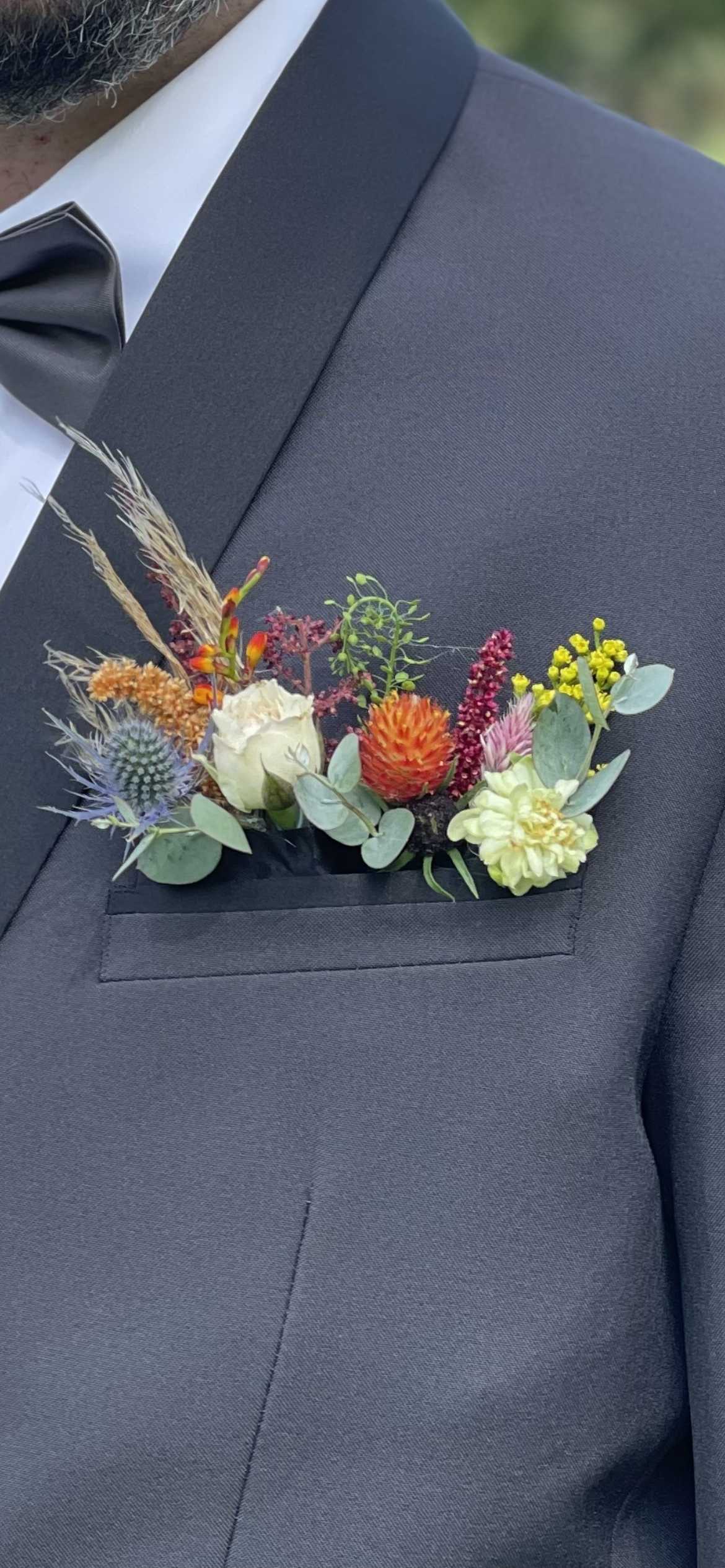 Colorful boutonniere on a dark suit jacket