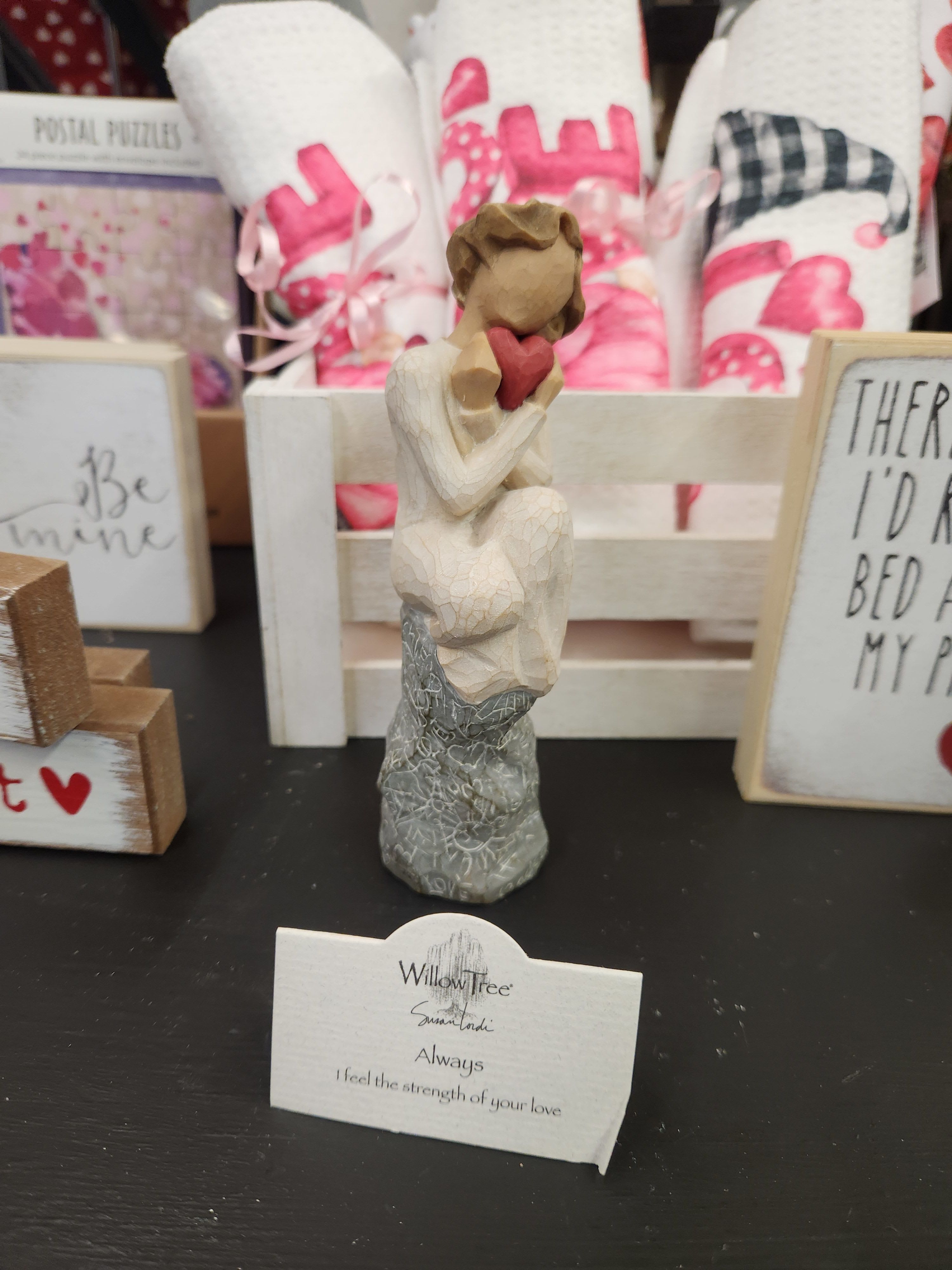 Small Willow Tree figurine of a seated figure holding a red heart