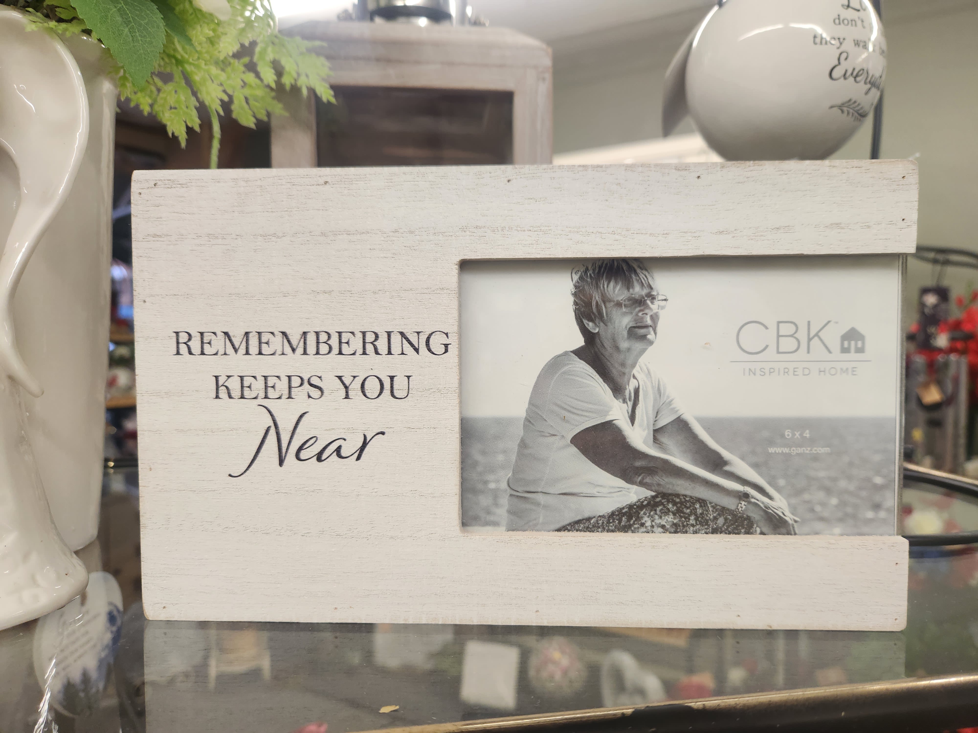 Wooden photo frame with the words "Remembering Keeps You Near"