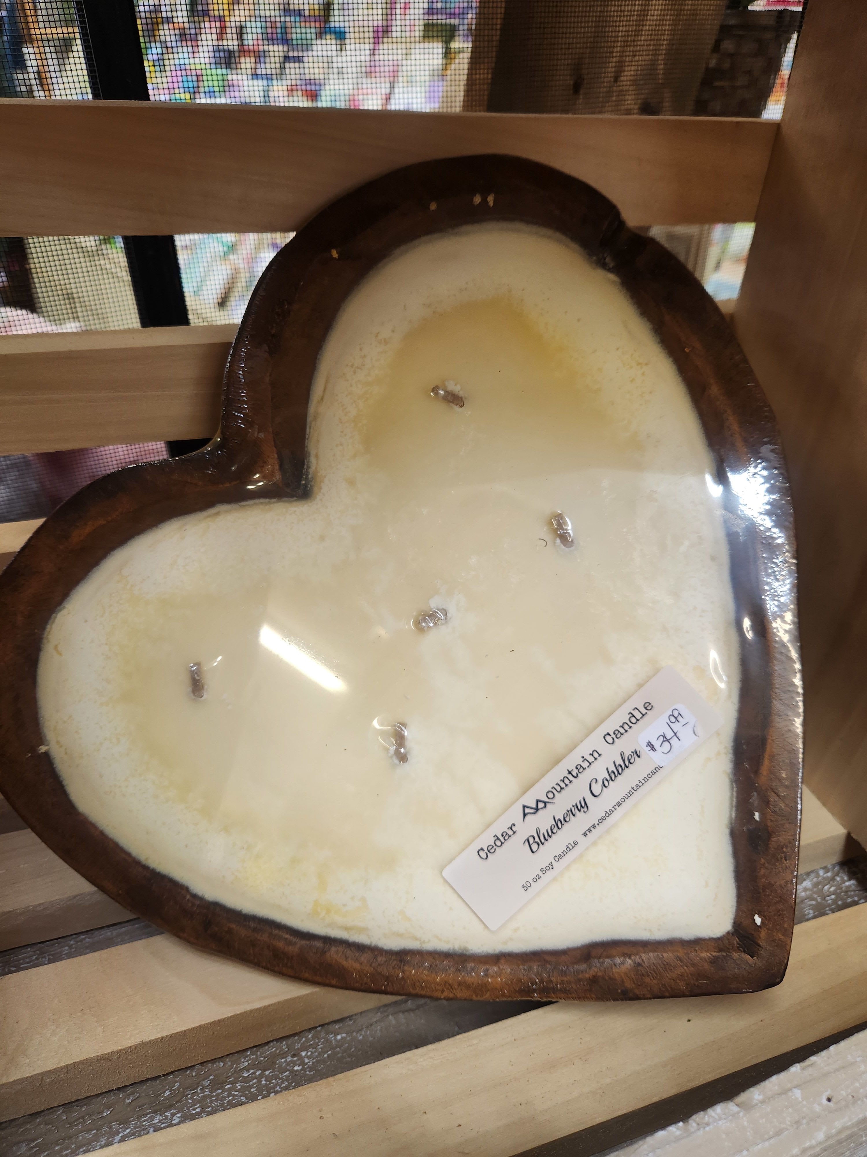 Heart-shaped candle in a wooden container