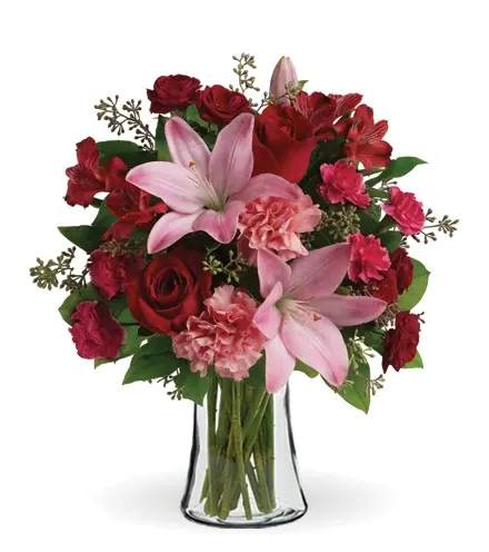 Red and pink mixed bouquet in a clear glass vase