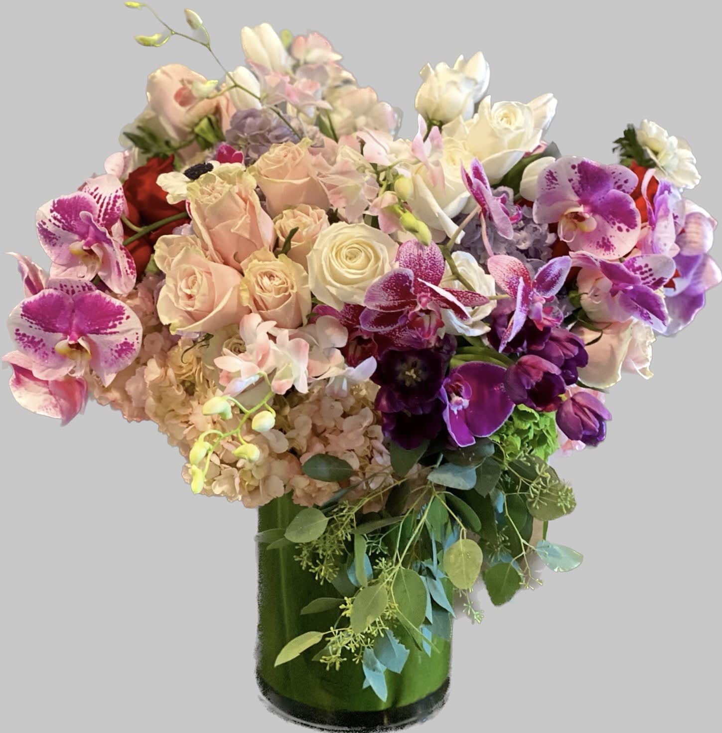 Bouquet of pink and purple flowers in a green glass vase