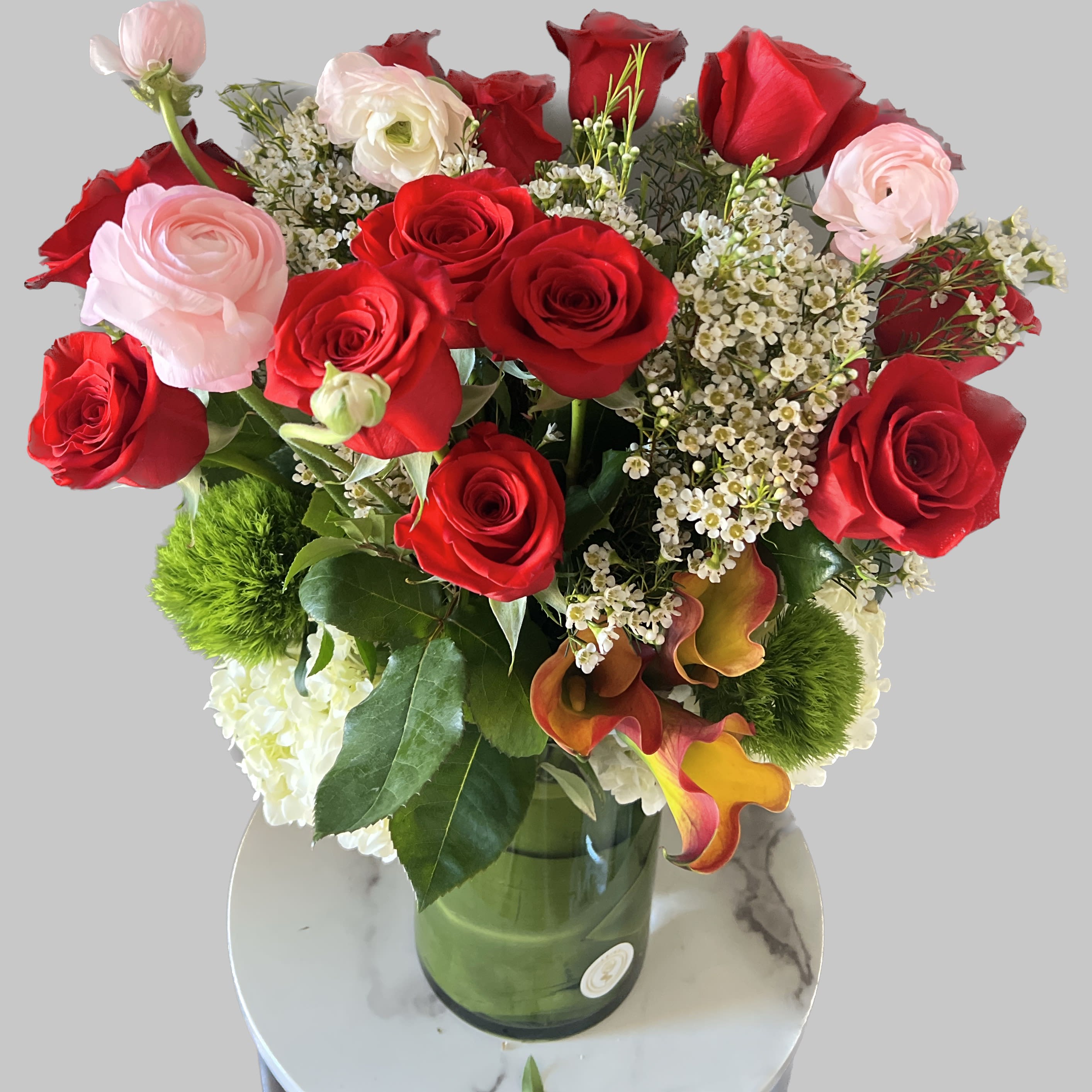 Bouquet of red and pale pink roses in a glass vase