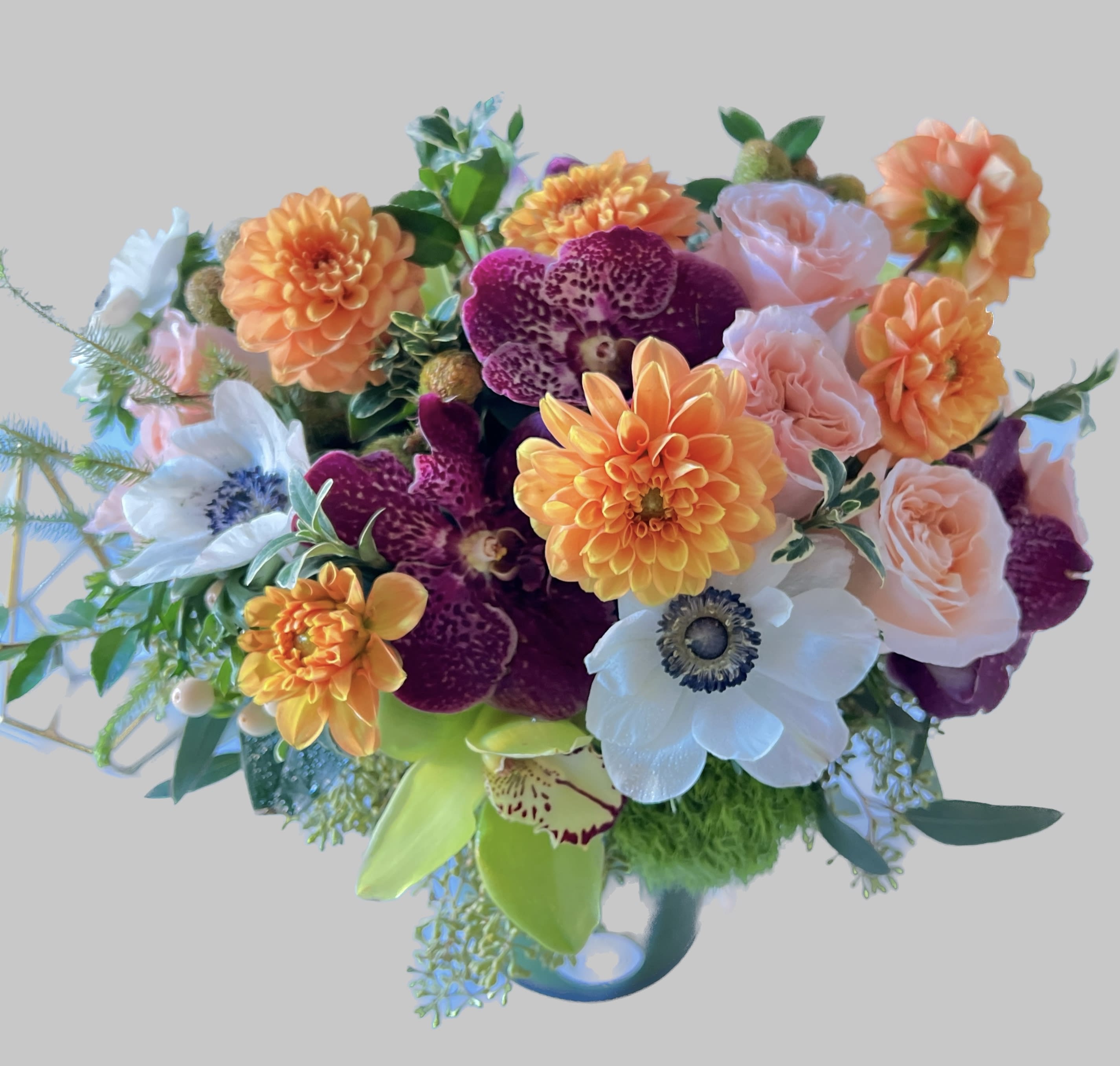 Colorful bouquet with orange dahlias, pink roses, and white anemones