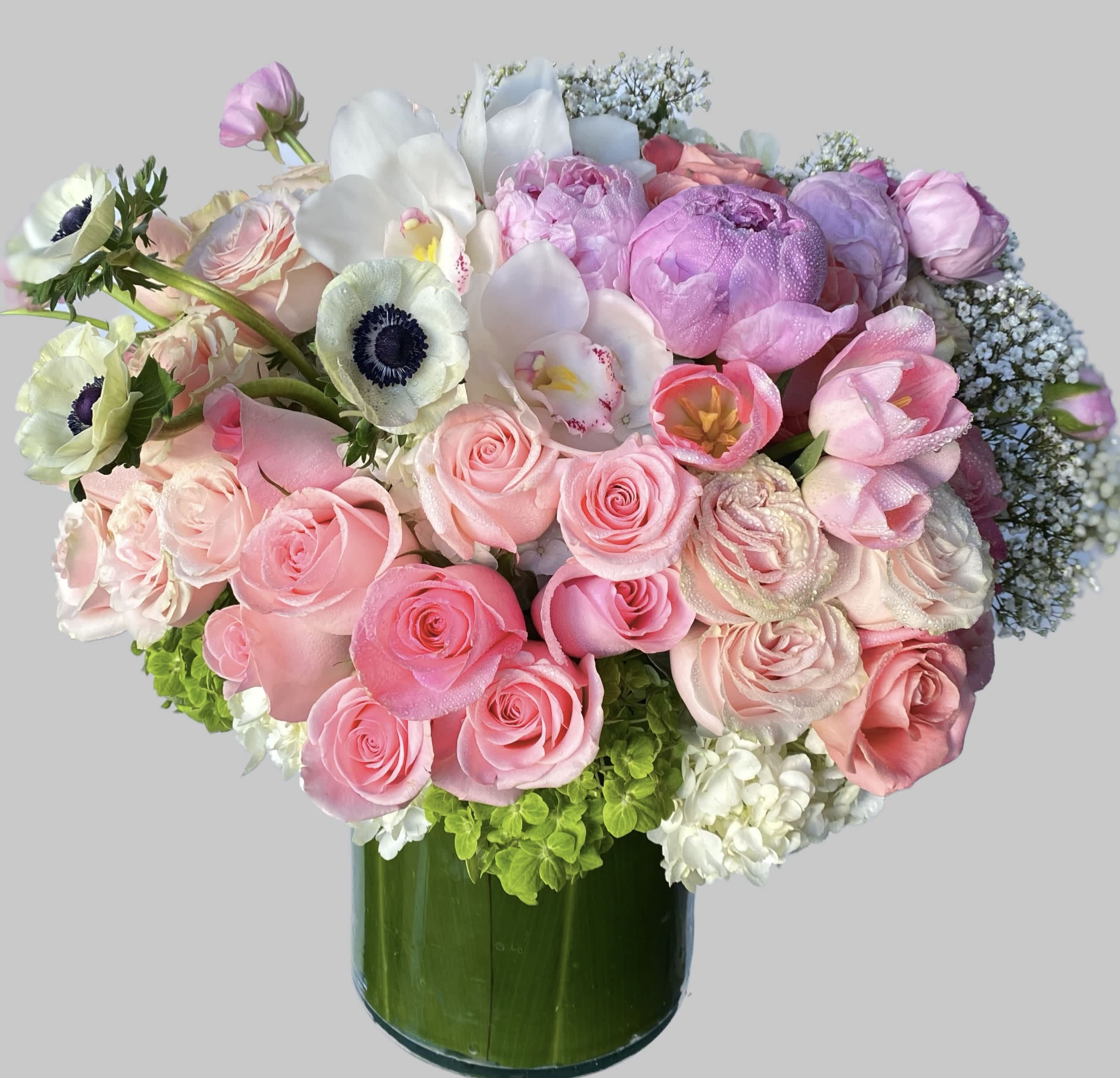 Pink and white mixed bouquet in a green glass vase