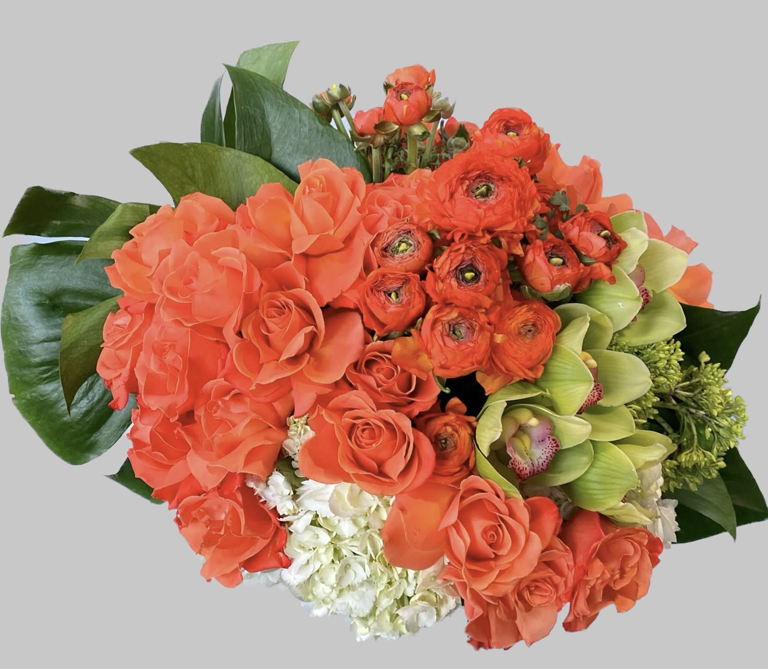 Bouquet of orange roses, ranunculus, and green orchids
