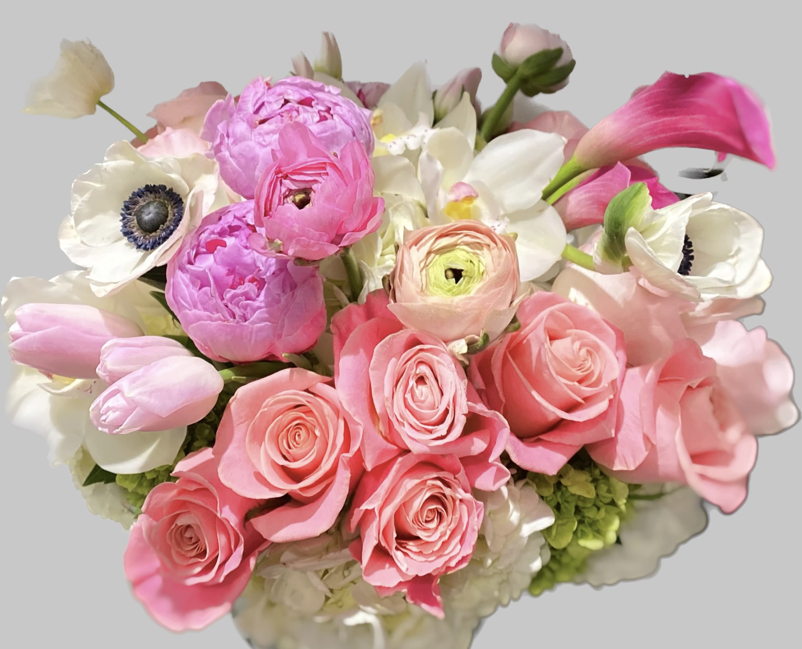Pink roses and white anemones with calla lilies in a bouquet