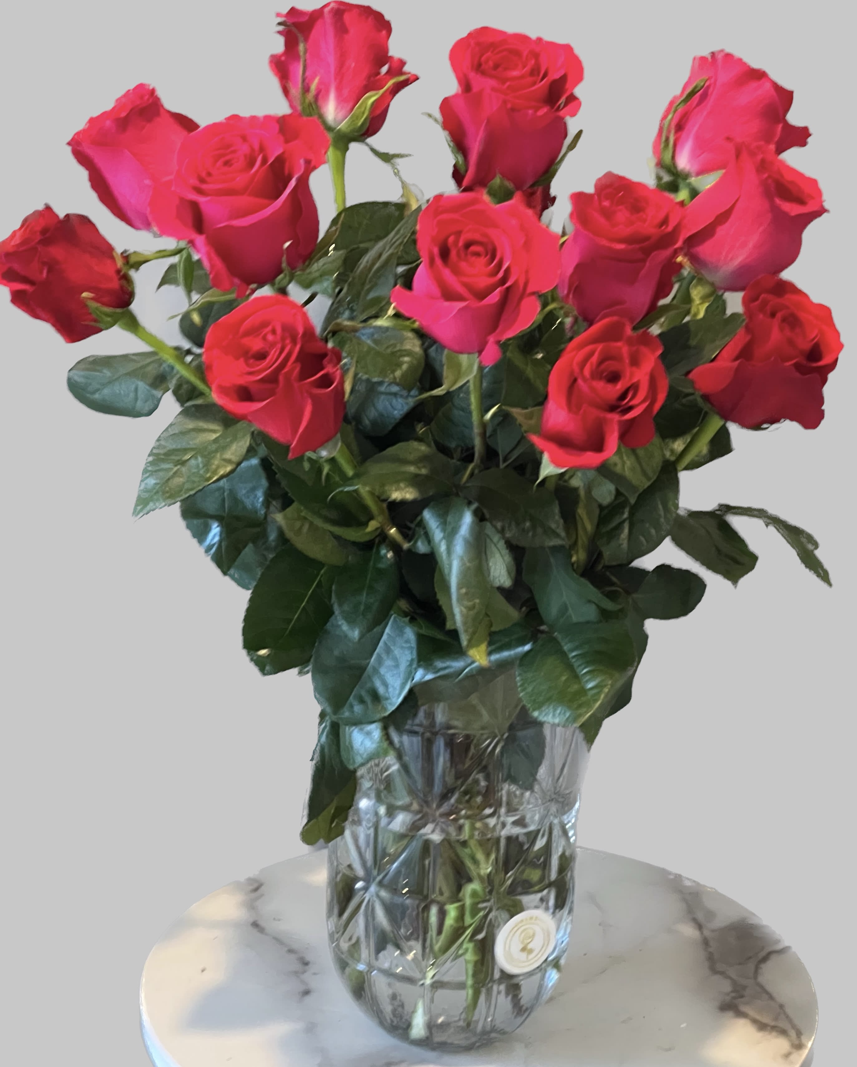 Bouquet of bright pink roses in a clear glass vase
