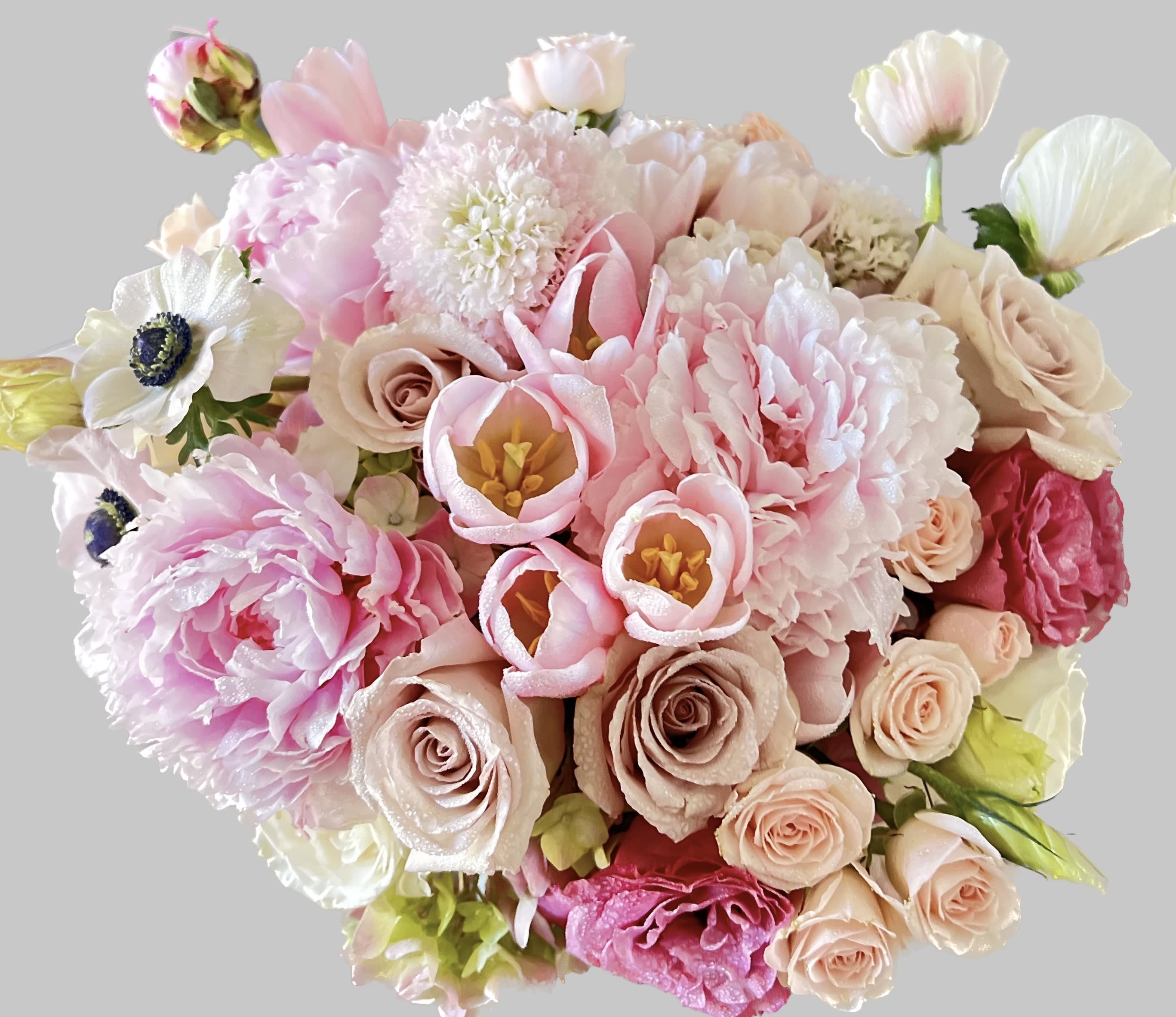 Bouquet of pink and cream flowers with roses and tulip-like blooms