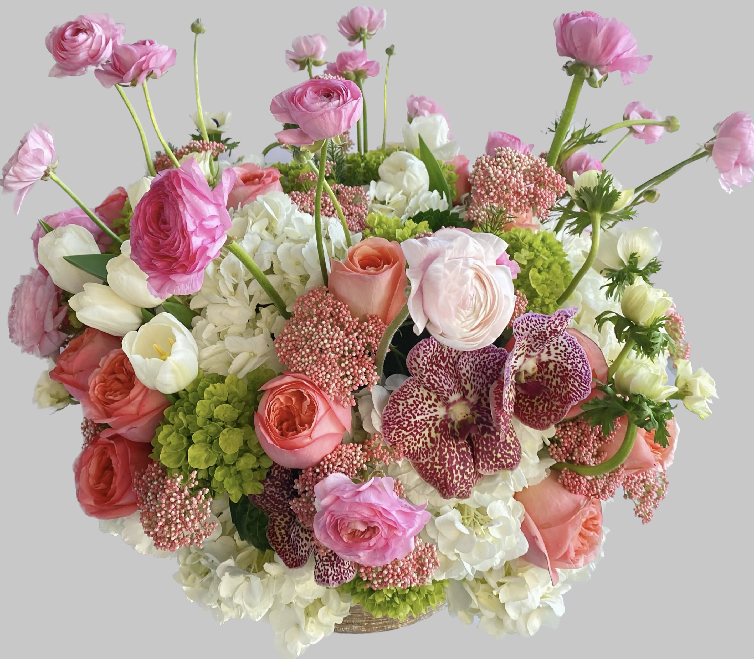 Pink and white mixed flower arrangement in a basket