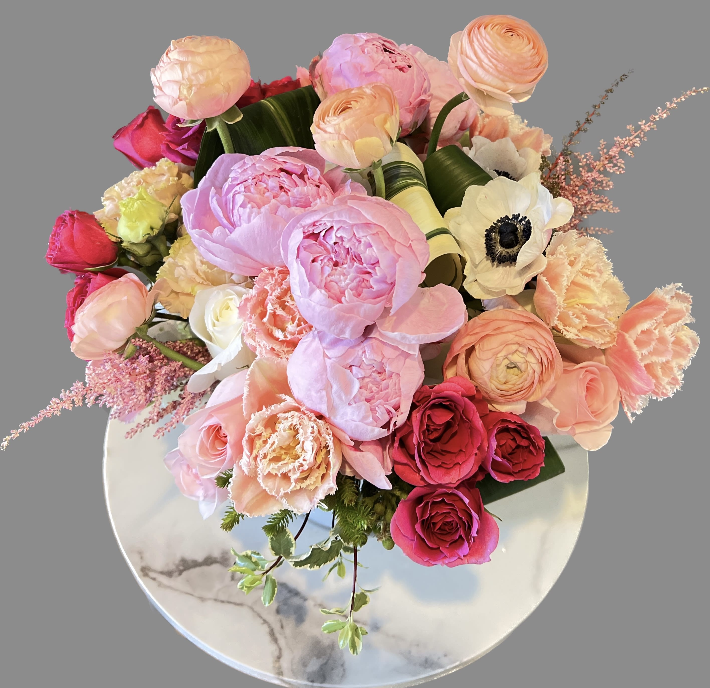 Bouquet of pink and peach flowers in a round vase