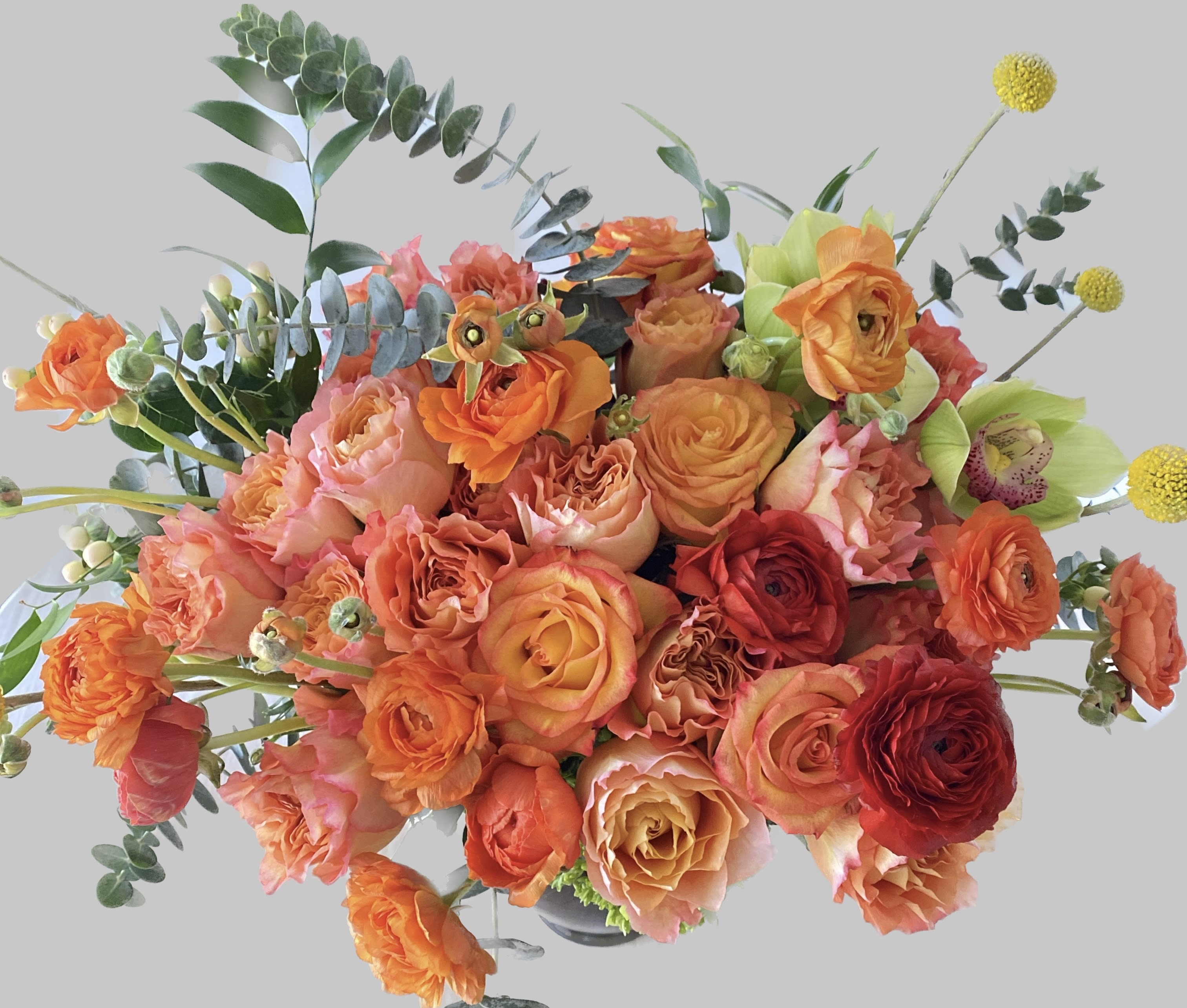 Seductive Orange Tangle - Fragrance fresh orange roses, orange ranunculus, touch of green within leaf lines gorgeous vase.  This flower arrangement will make them happy and refresh.