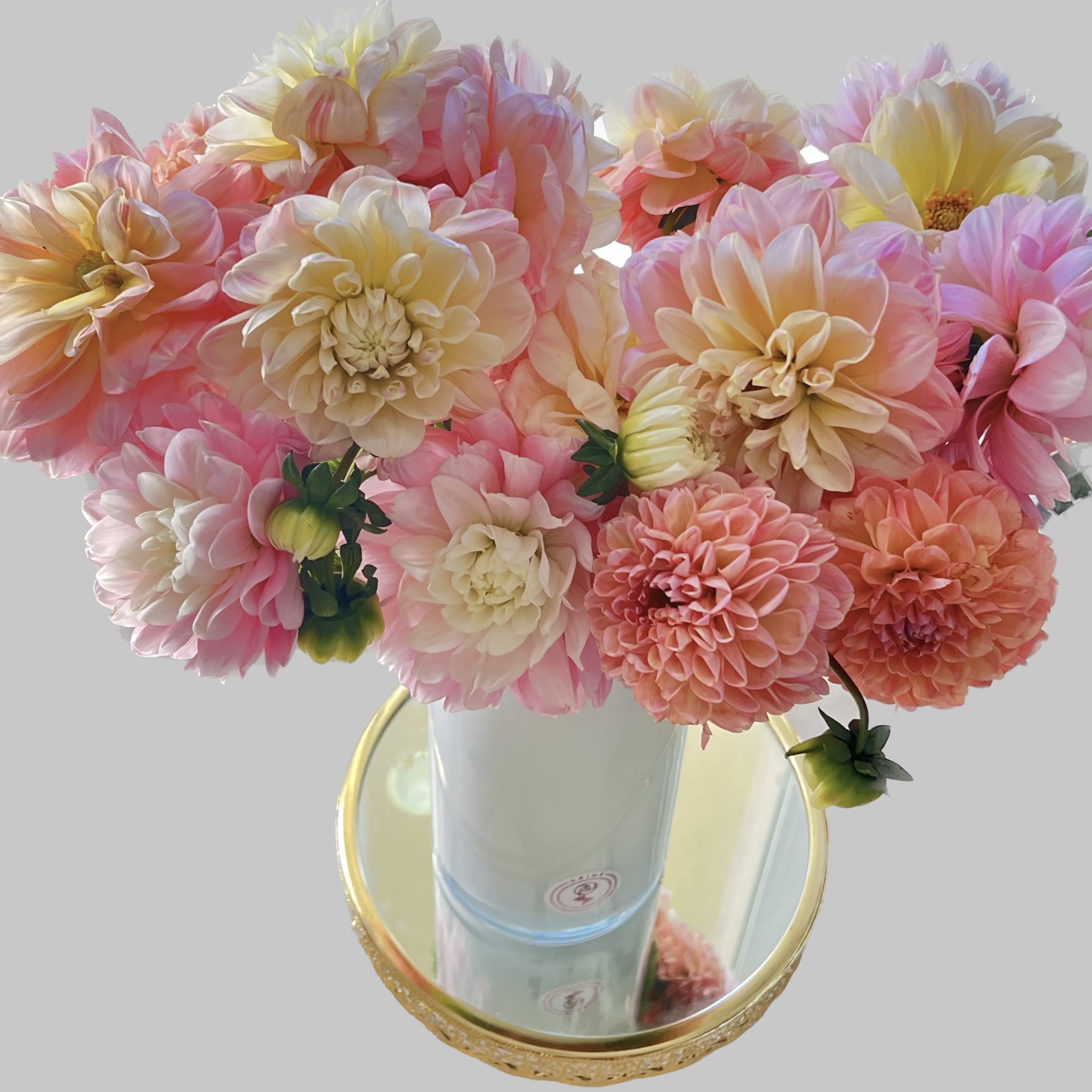 Pink and peach dahlia bouquet in a white vase