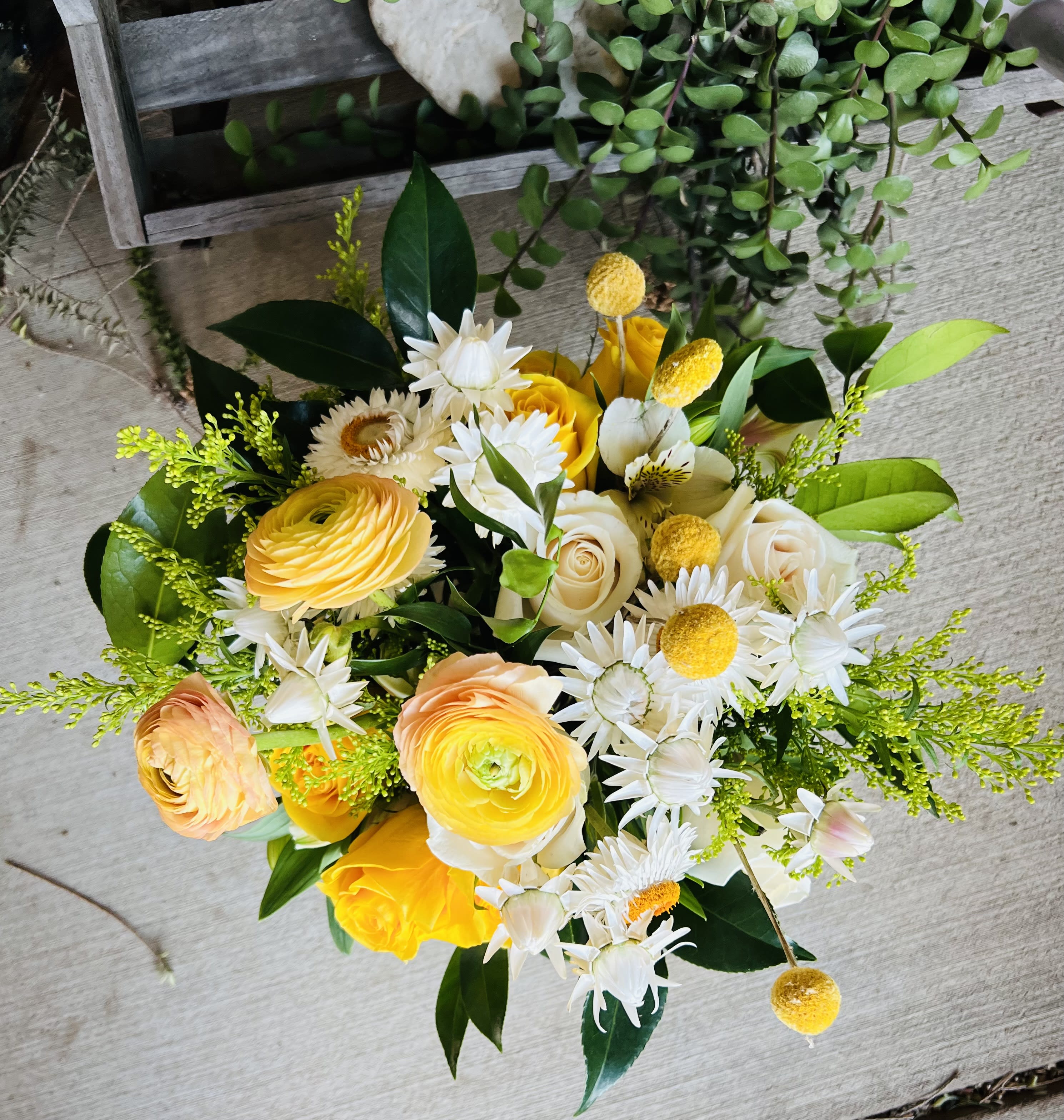 Bouquet of yellow and white flowers with green foliage