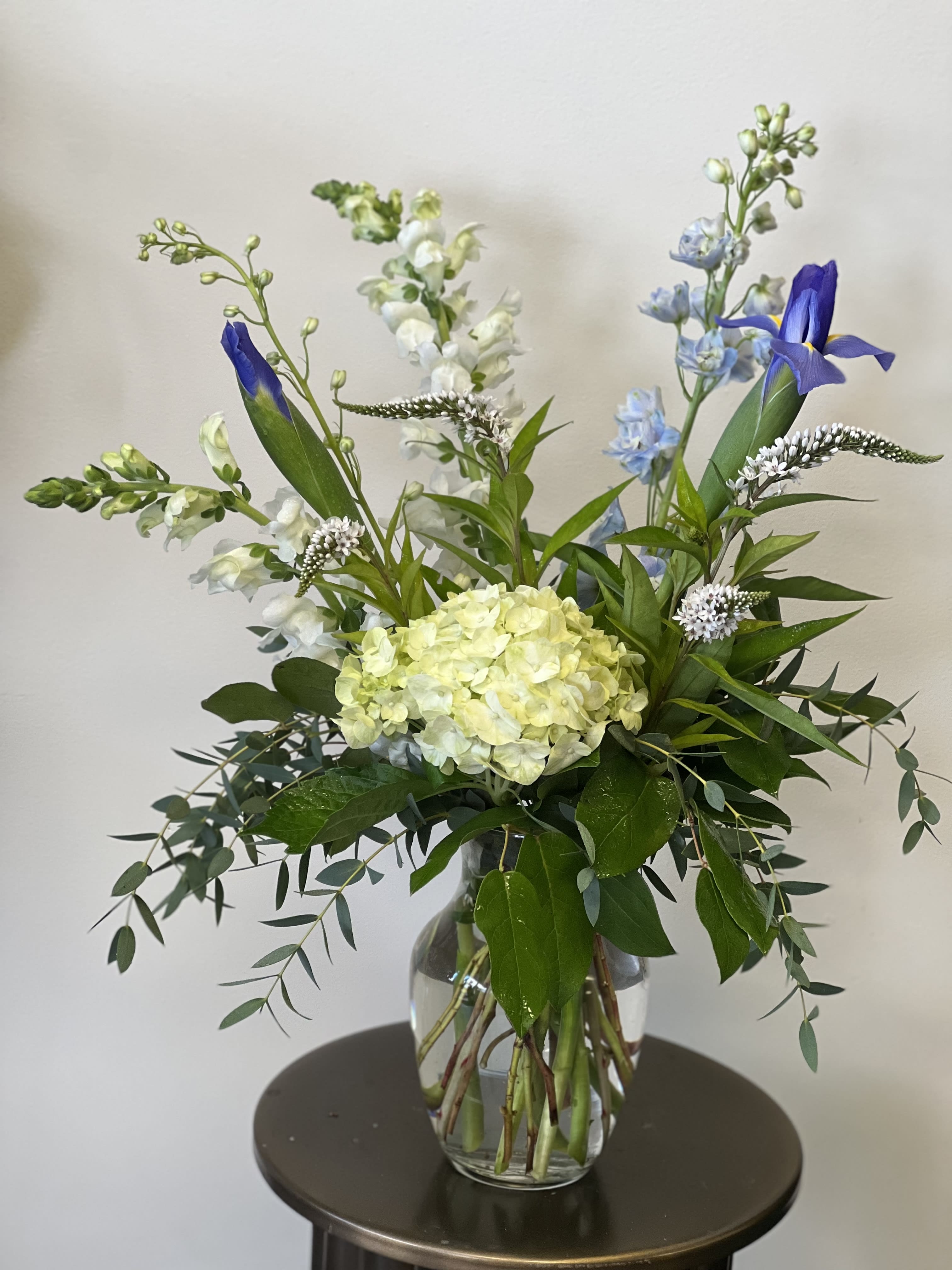 Summer Romance  - This simple but elegant arrangement has hydrangea, Iris, snapdragons, delphinium and more. It’s sure to make someone’s day. 