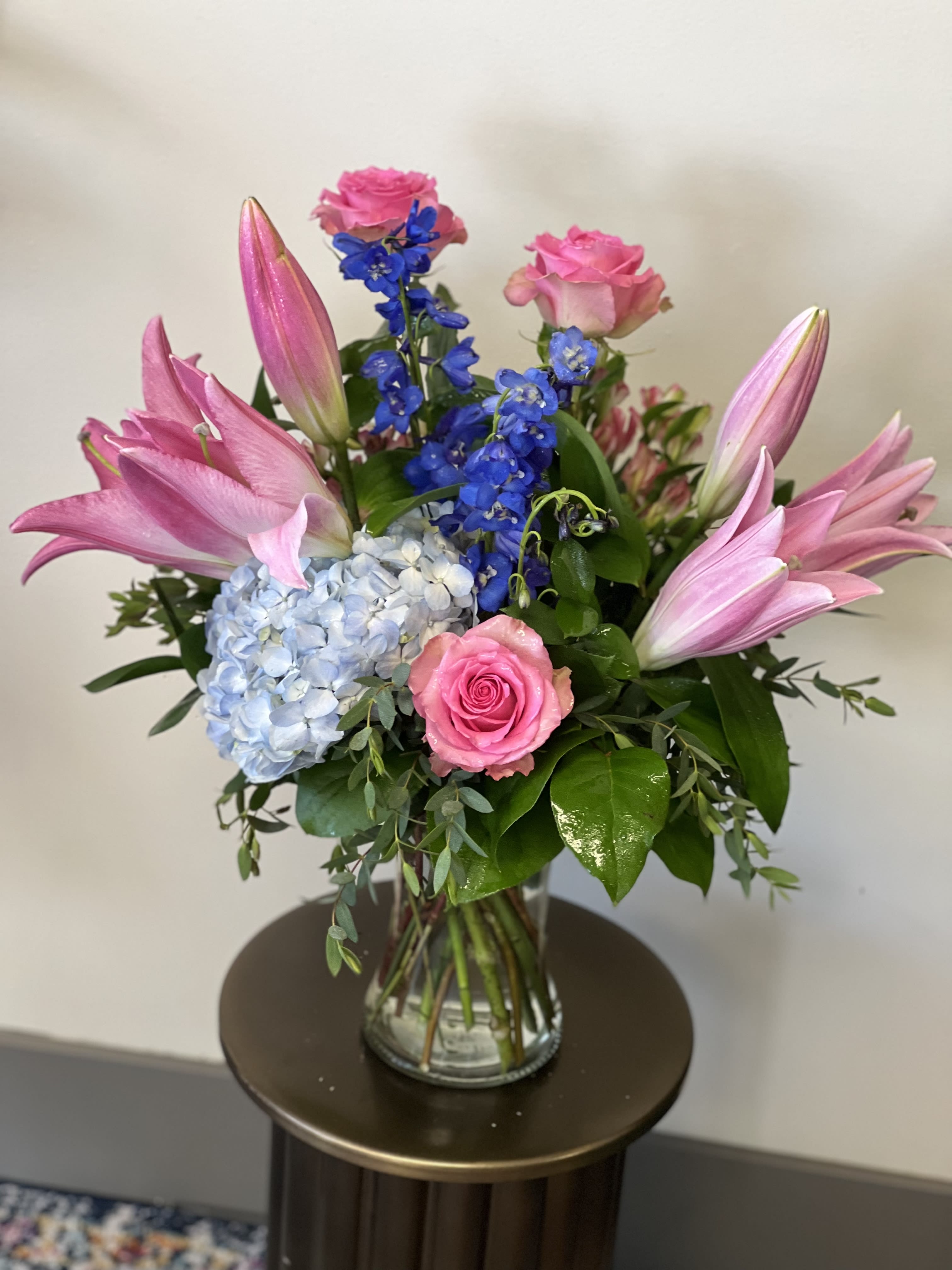 Serendipity  - This delightful arrangement has hydrangea, lily’s, roses and delphinium. 