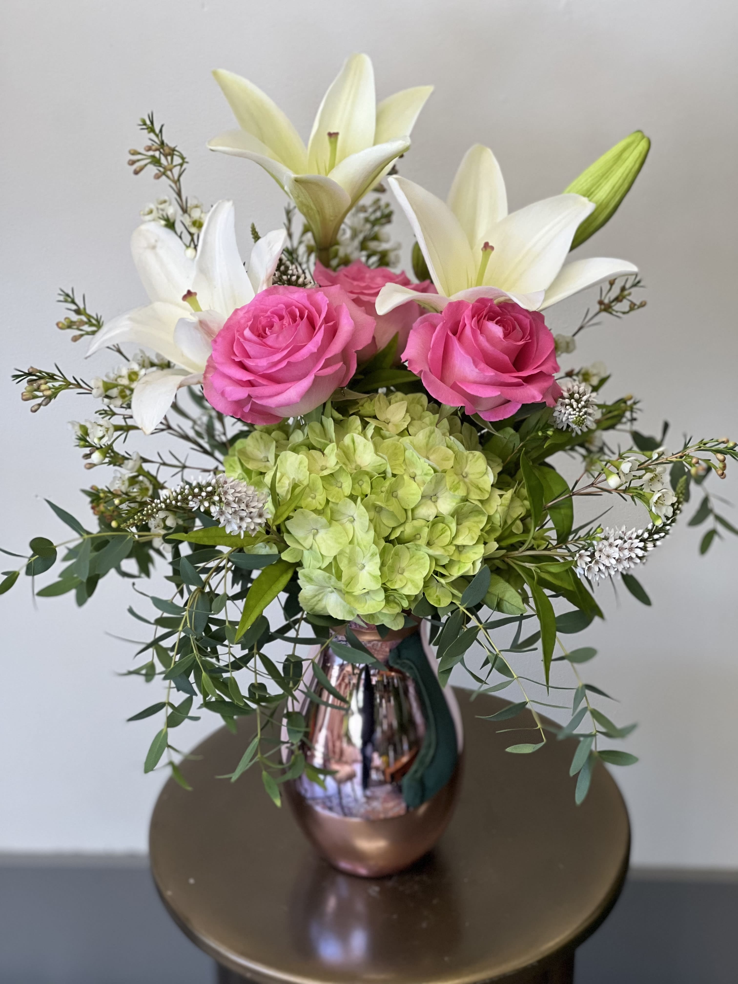 Beautiful Betty - This beautiful arrangement has hydrangea, lily’s and roses in a spectacular pink vase. 