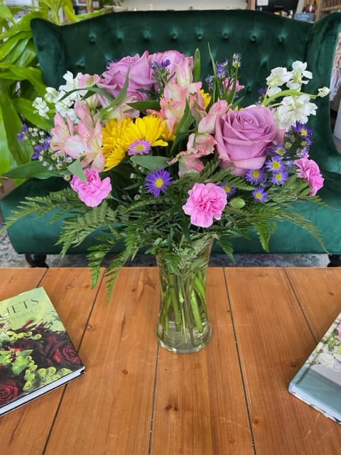 Lady Lavender - A lavender-themed arrangement featuring roses, daisies, alstroemerias, stock, mini carnations, and asters.