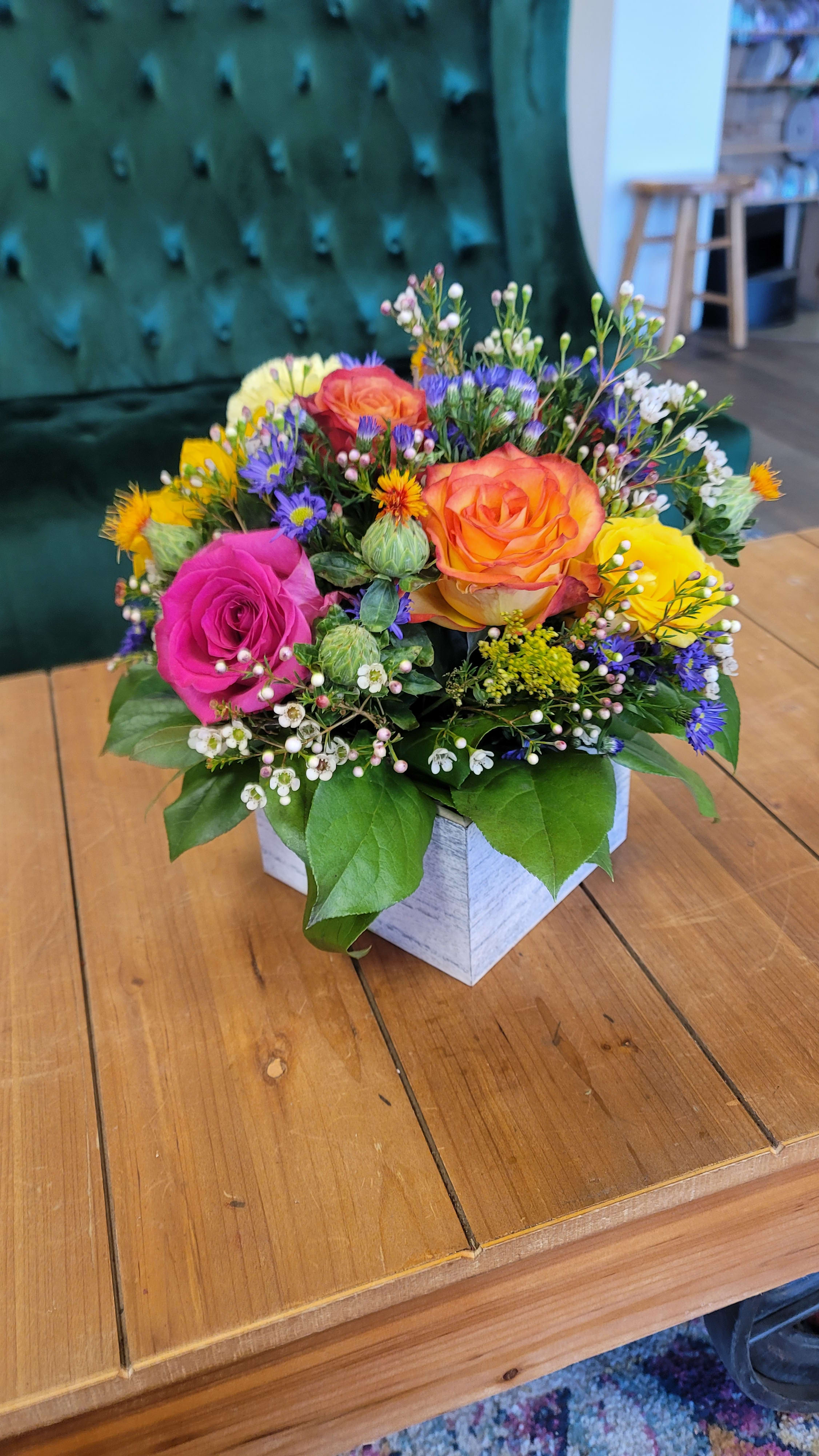 Colorful rose bouquet in a white square box