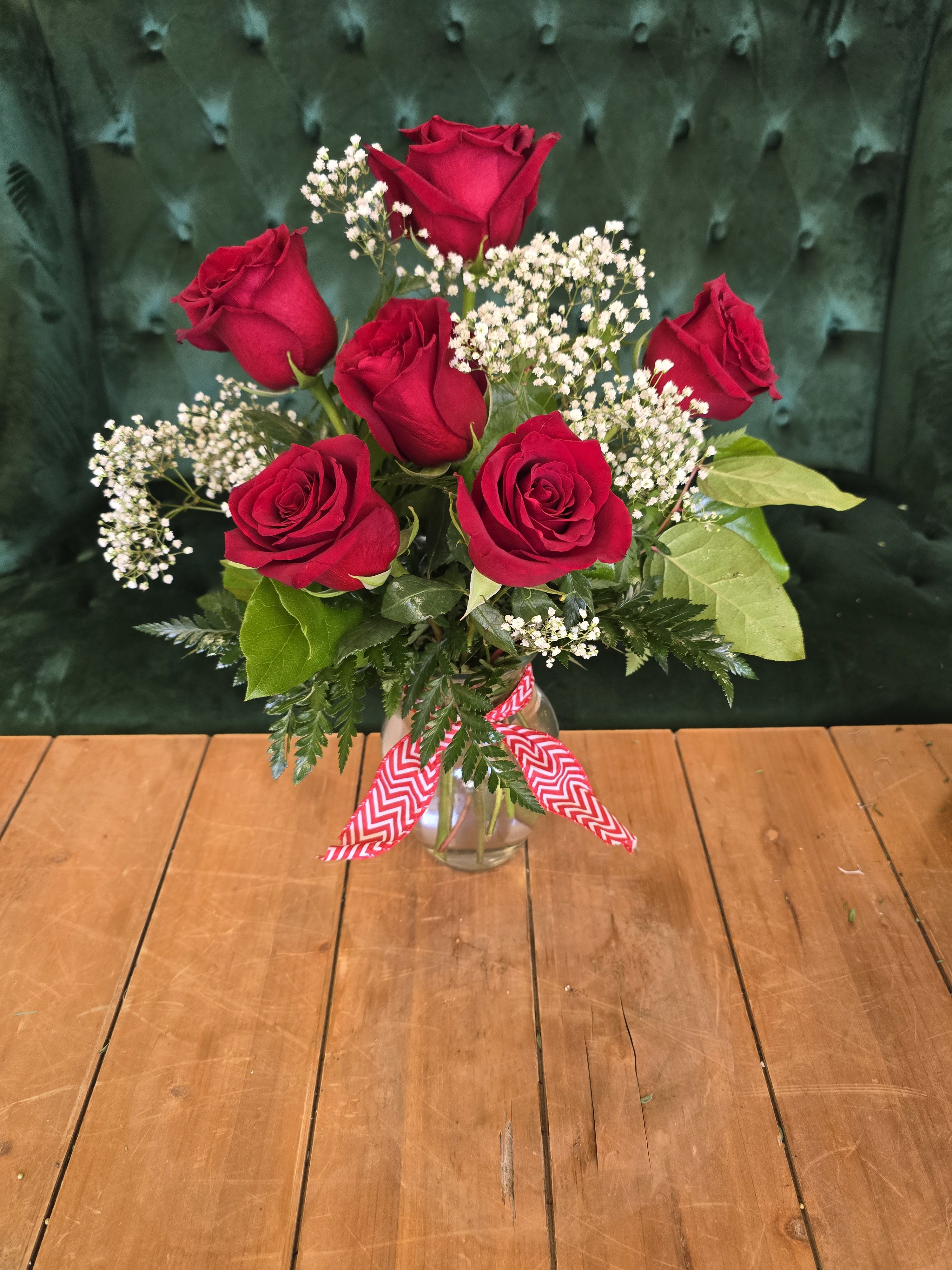 Roses for my love - 6 red roses with baby's breath and greens in a an 8 inch Jordan vase.  