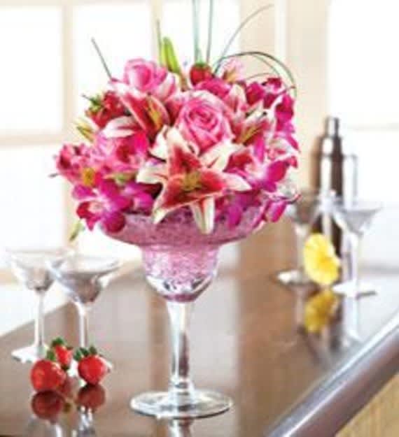Pink and white floral arrangement in a tall glass goblet