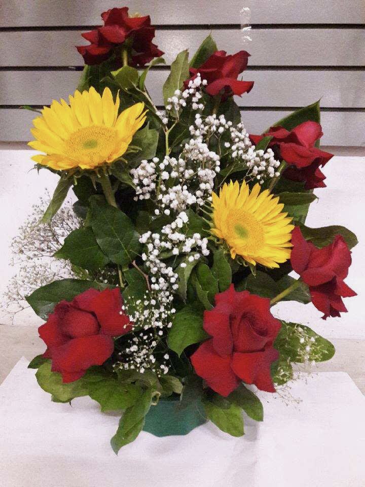 Bouquet of red roses, yellow daisies, and white baby's breath