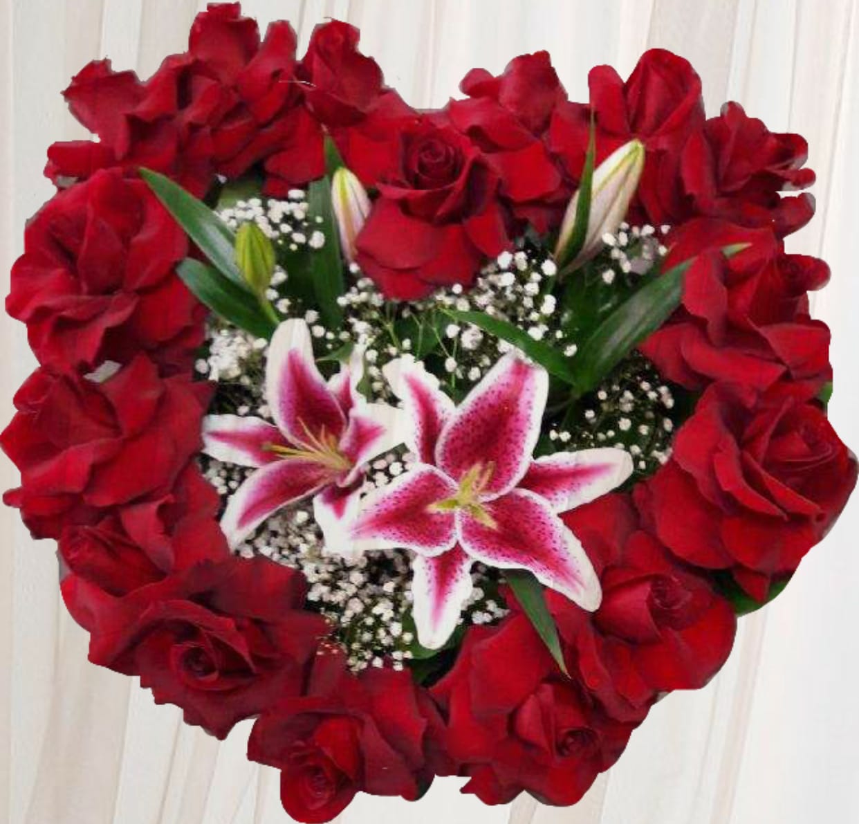 Heart-shaped bouquet of red roses with pink lilies