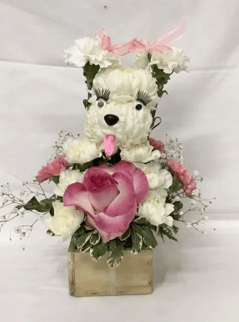White floral teddy bear arrangement with pink accents on a box base