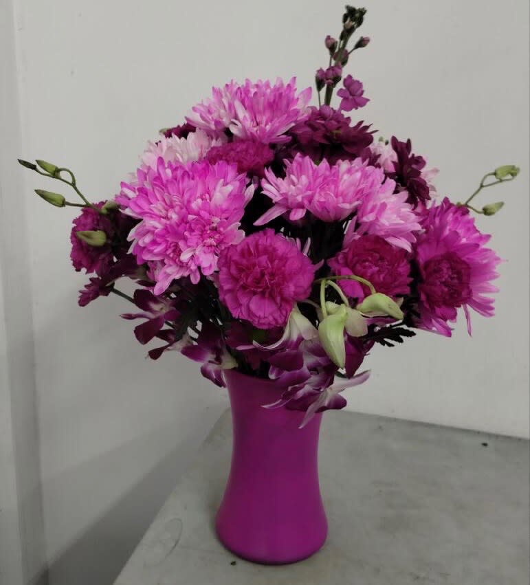 Pink and purple bouquet in a magenta vase