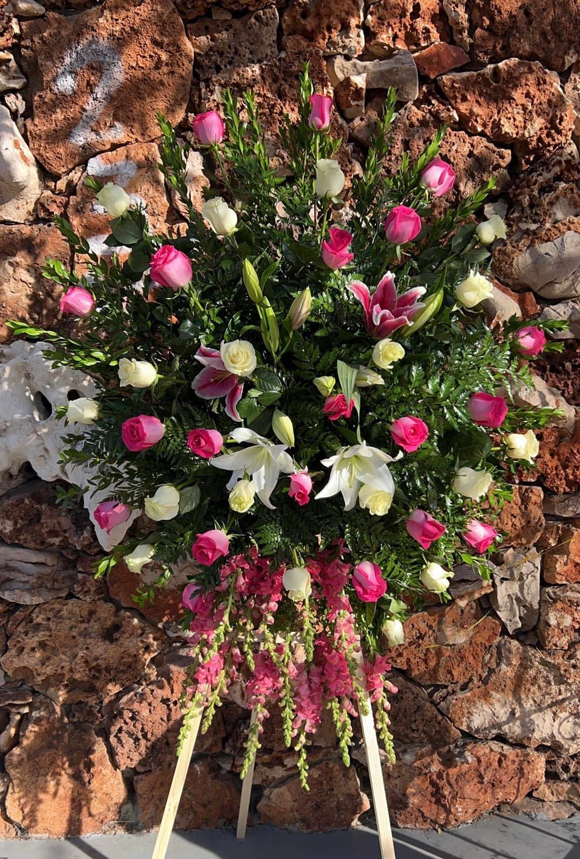 Standing floral spray with pink and white roses and lilies
