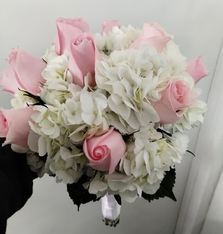 Pink roses and white hydrangeas in a hand-tied bouquet