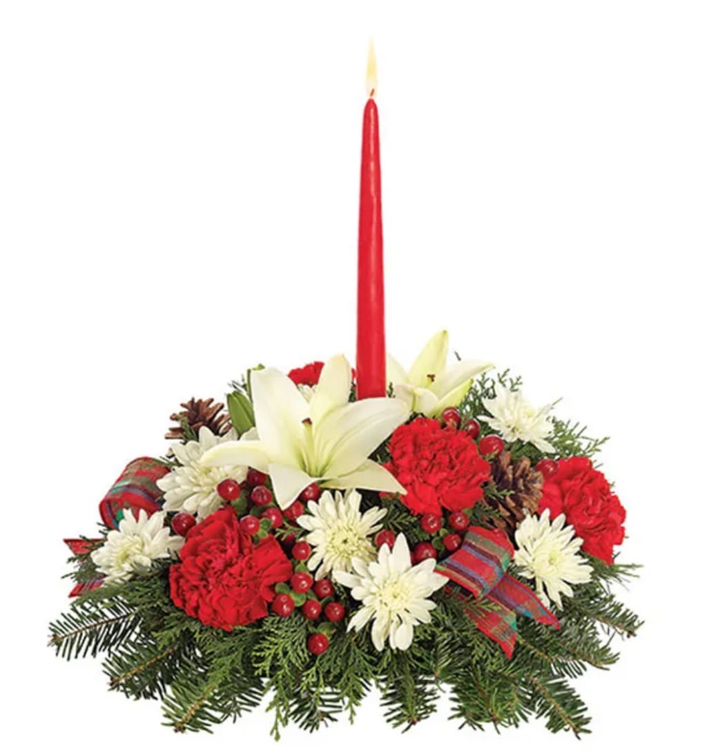 Holiday centerpiece with red candle, white lilies, and red-and-white flowers