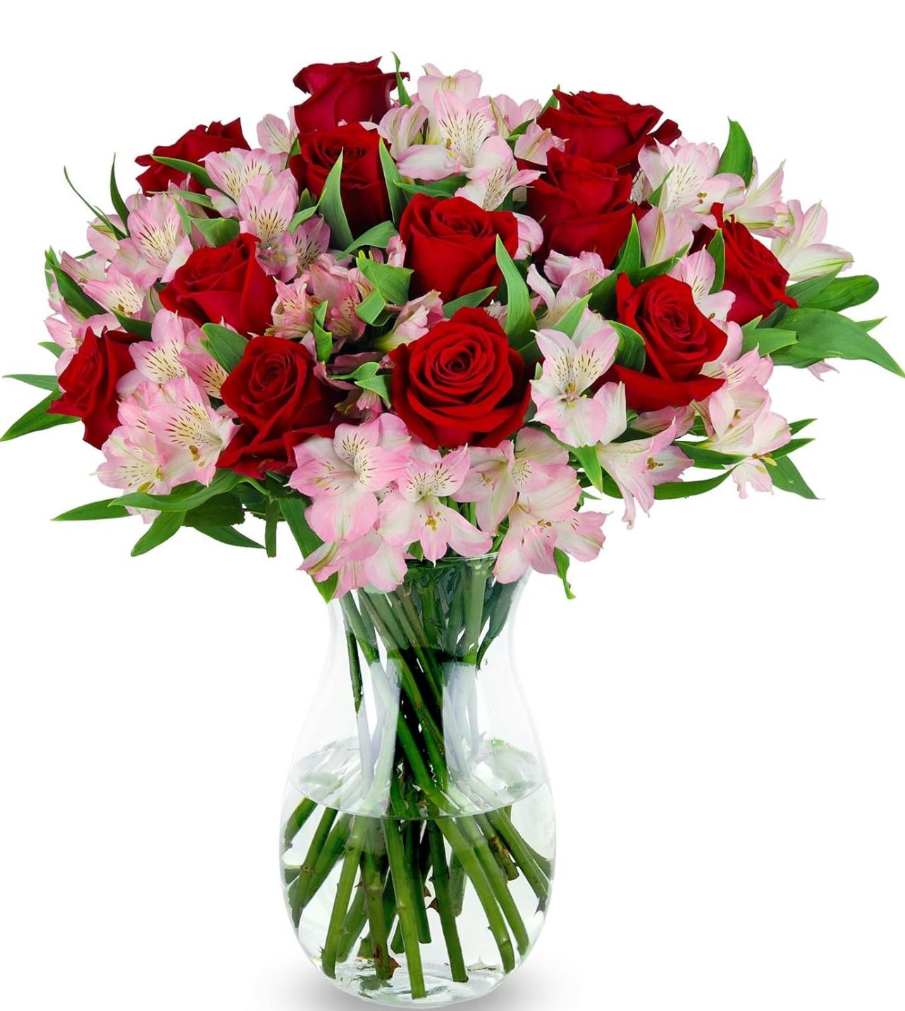 Red roses and pink alstroemeria in a clear glass vase