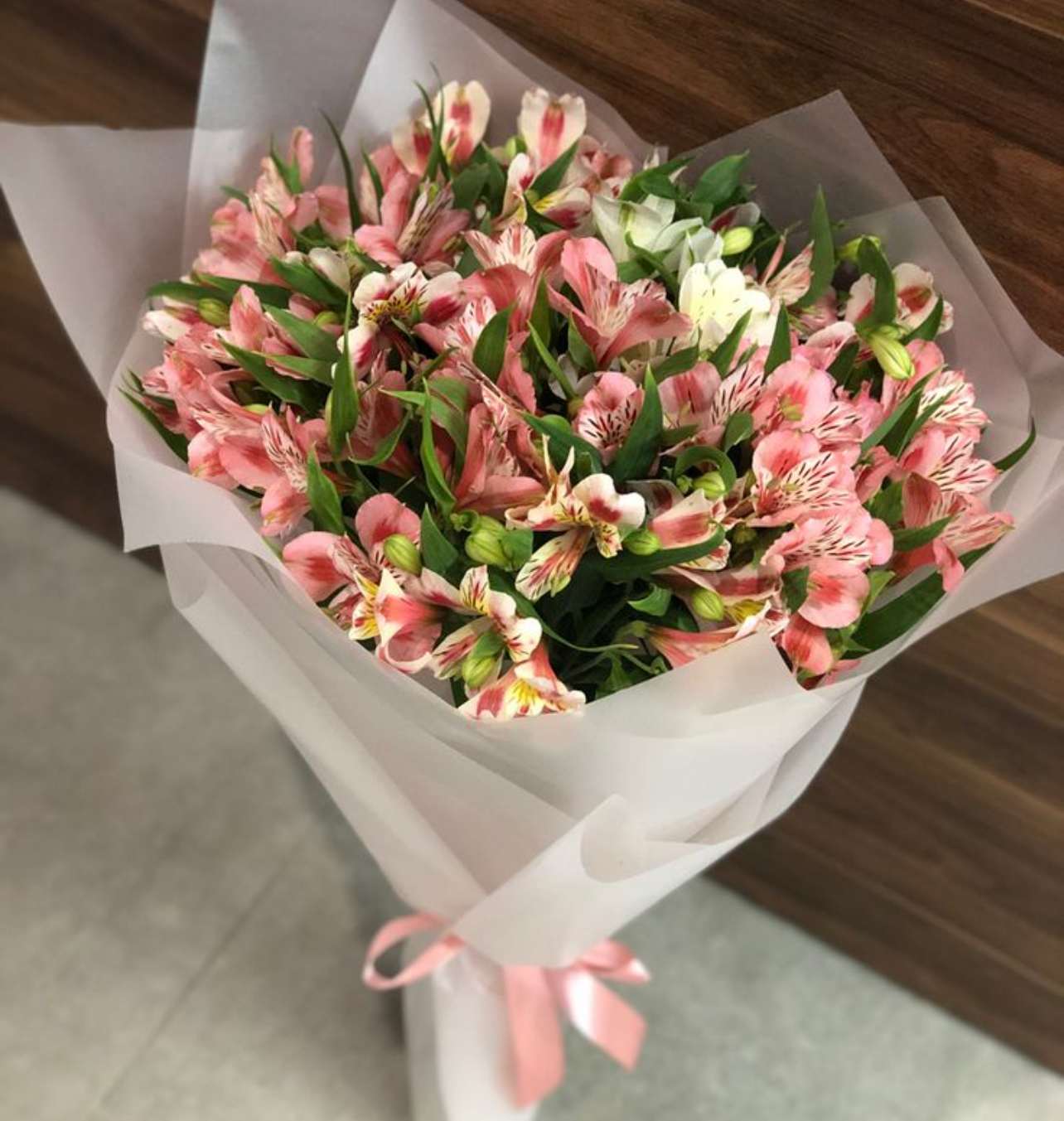 Bouquet of pink and white alstroemeria wrapped in white paper