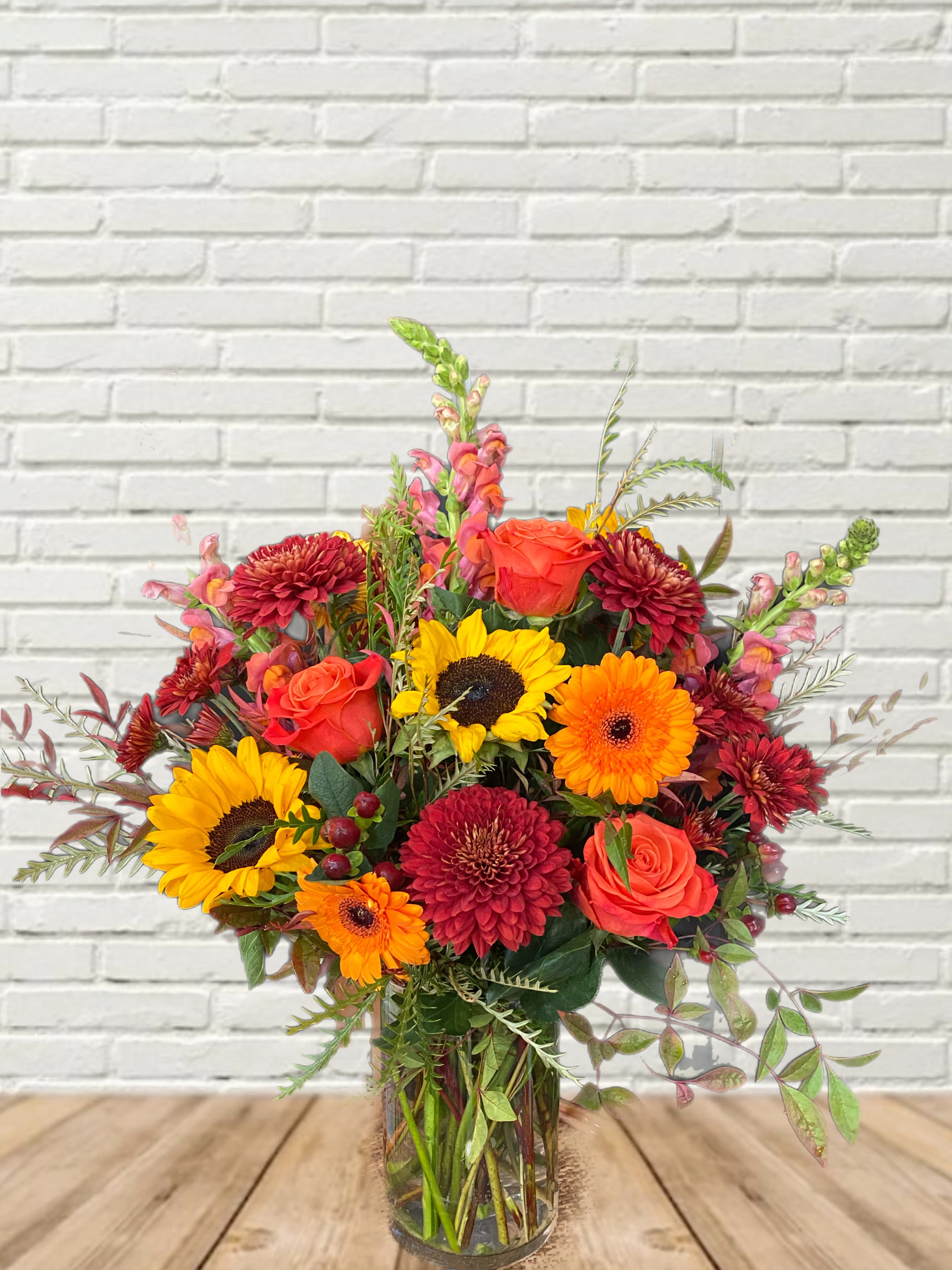 Fall Breeze &amp; Autumn Leaves - A sunny bright fall arrangement featuring sunflowers, marigolds, roses, gerbera daises, &amp; local fall greenery!