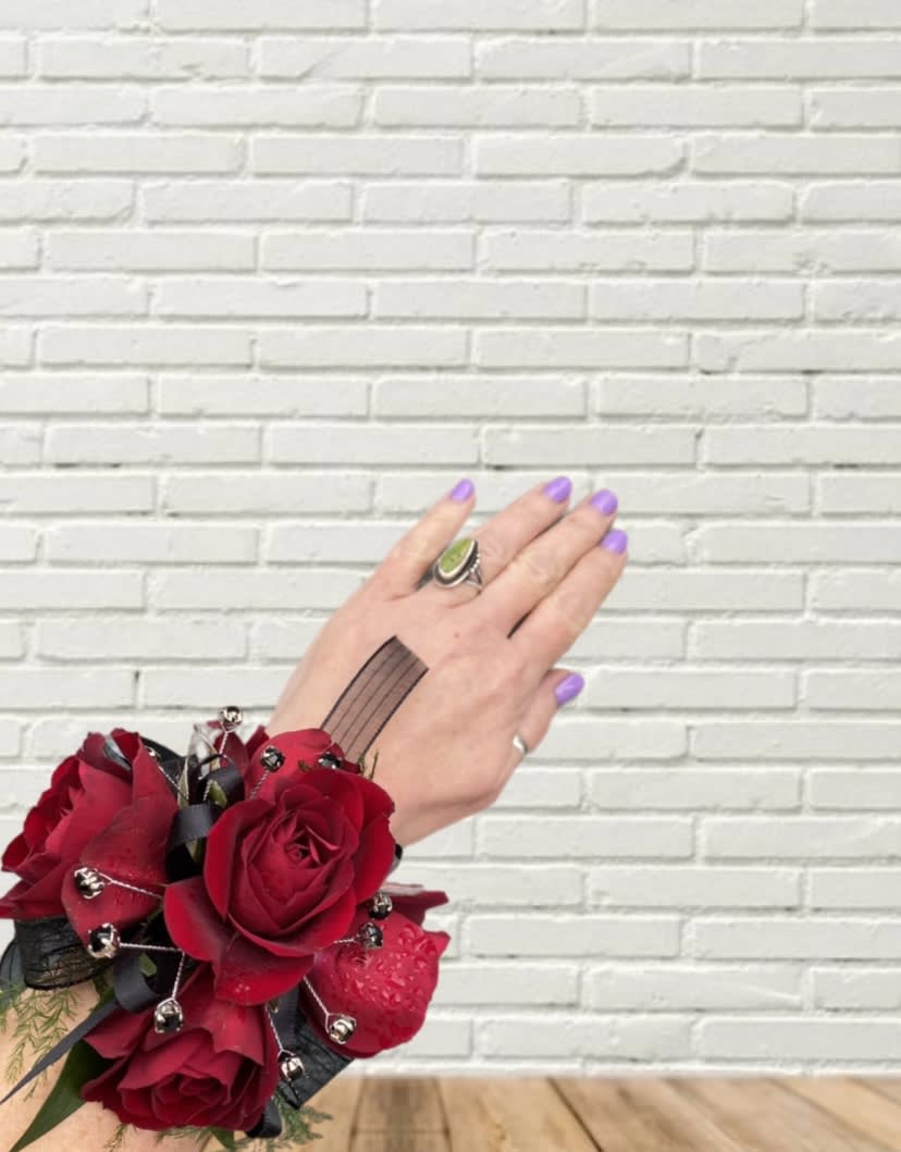 Red rose wrist corsage with black ribbon and silver accents