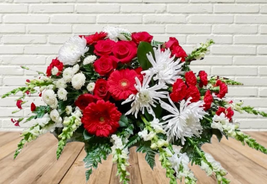 Red and white mixed flower arrangement with daisies and roses