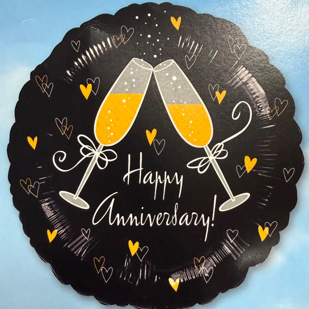 Black anniversary balloon with two champagne flutes and heart accents