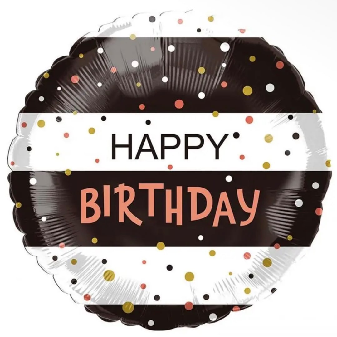 Round birthday balloon with black, white, and confetti dots