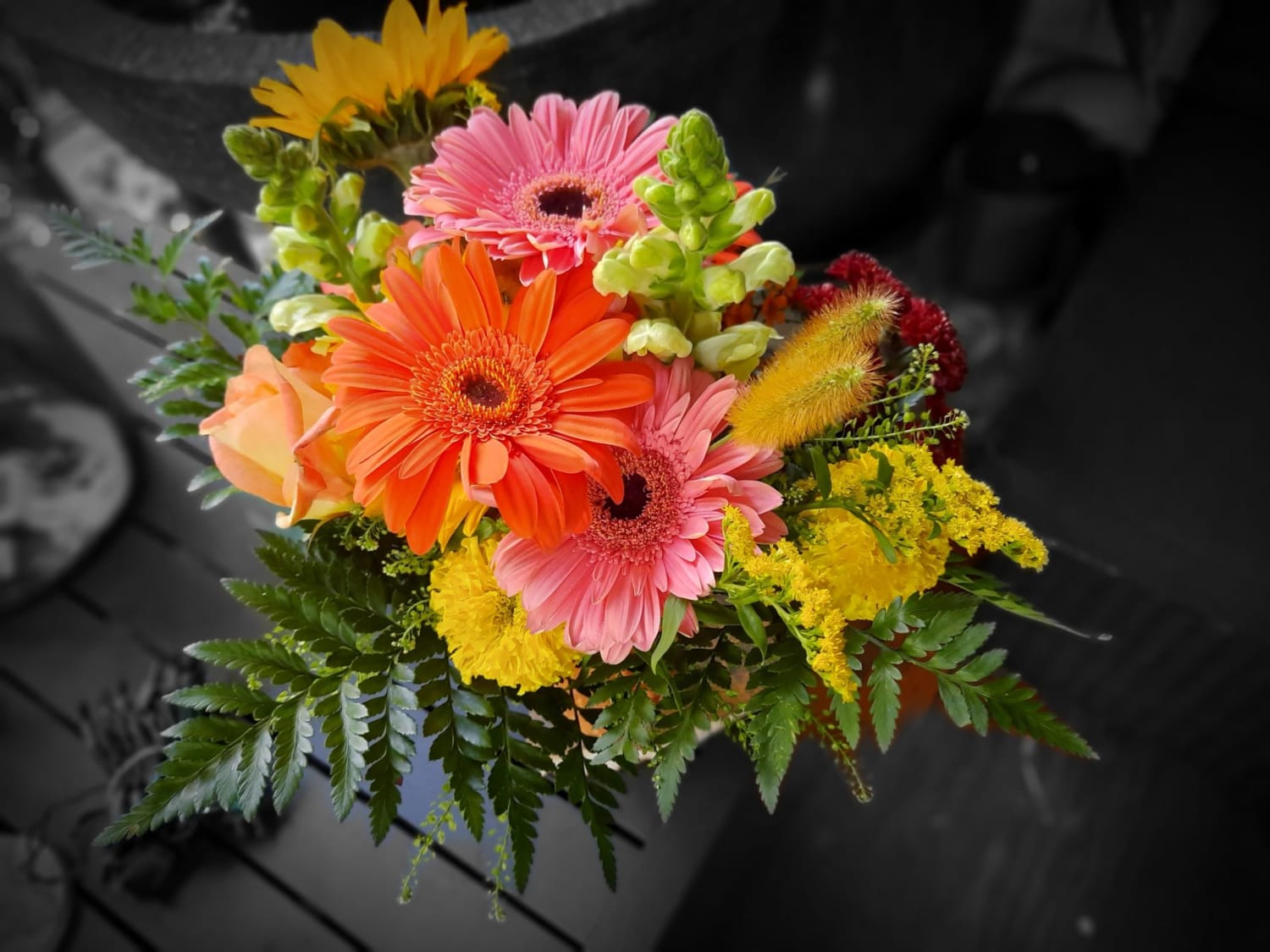 Bright mixed bouquet with gerbera daisies, roses, and yellow filler flowers