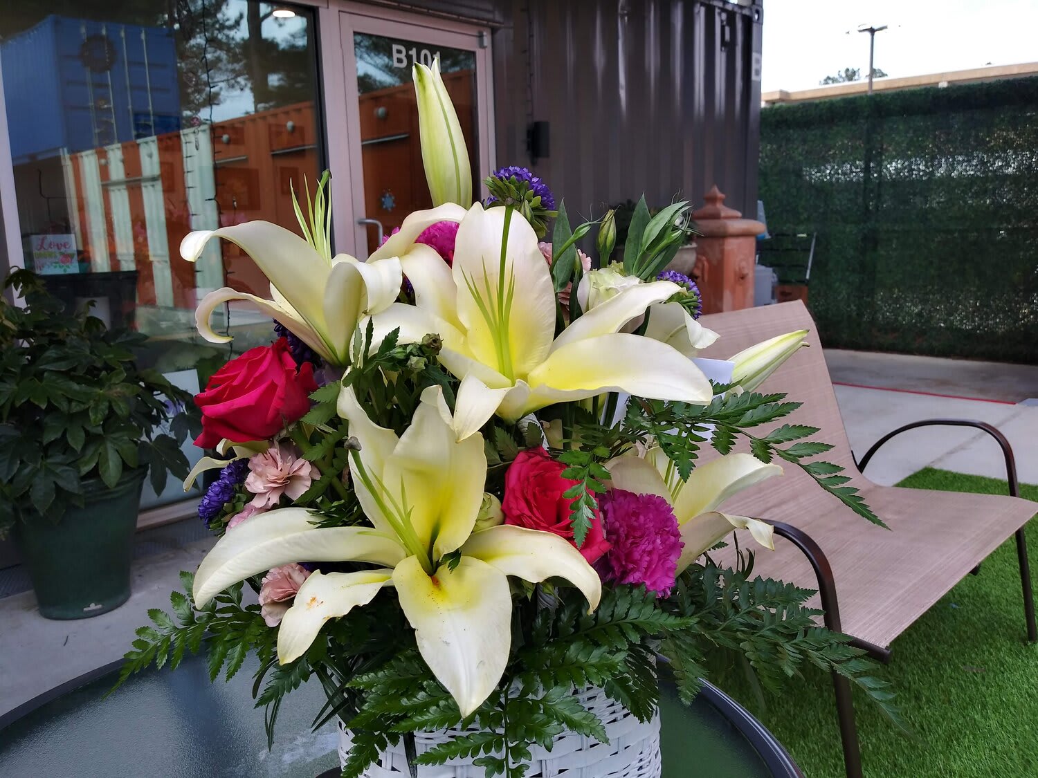 Bouquet of white lilies and pink roses in a white basket