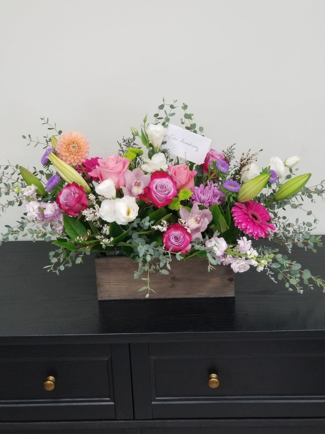 Mixed pink and white flower arrangement in a wooden box