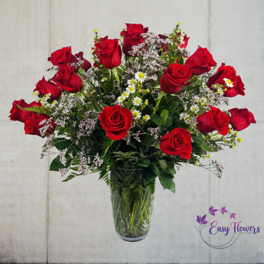 Three Dozen Premium Long Stem Red Roses - Experience the power of love with our premium long-stemmed rich red roses, expertly arranged in an elegant clear glass pedestal vase. Our 24-inch roses are sure to make your heart skip a beat and create a dazzling display of beauty that will bind your hearts together as one. This timeless tradition will connect your past and future in a way that is unforgettable.