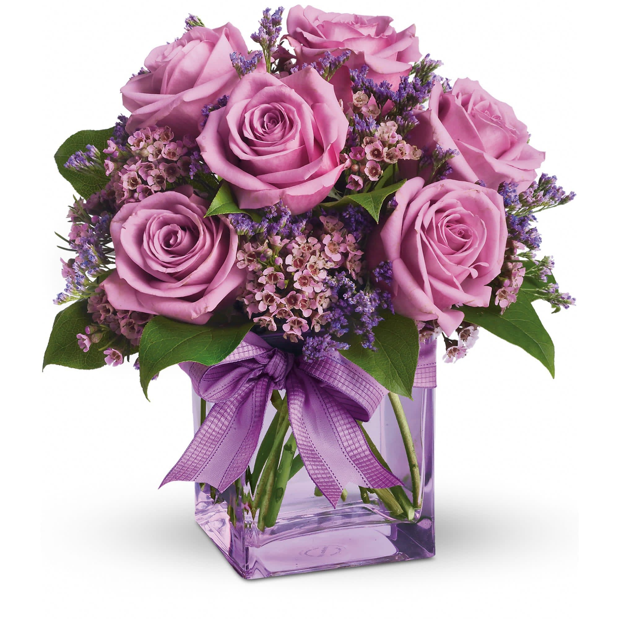 Lavender rose bouquet with small purple blooms in a square lavender glass vase with matching ribbon