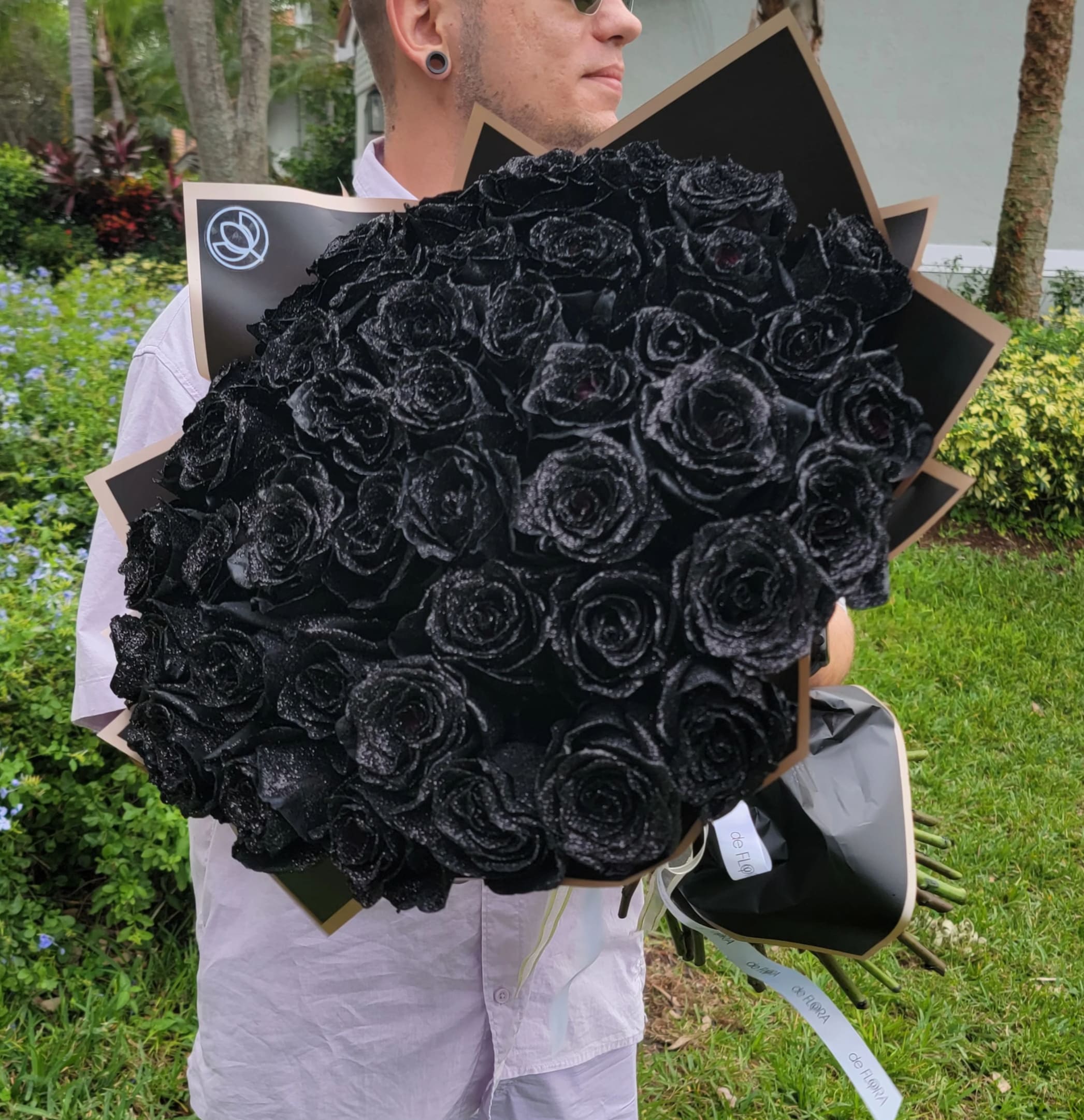 Large bouquet of black roses wrapped in black paper